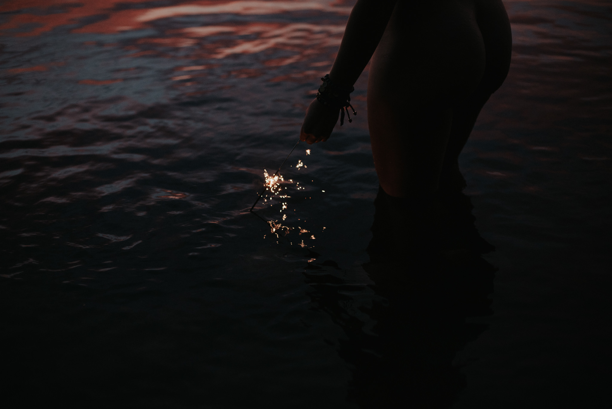 Feminine portraits in the water with sparklers at sunset. Georgian Bay, Ontario // www.daringwanderer.com