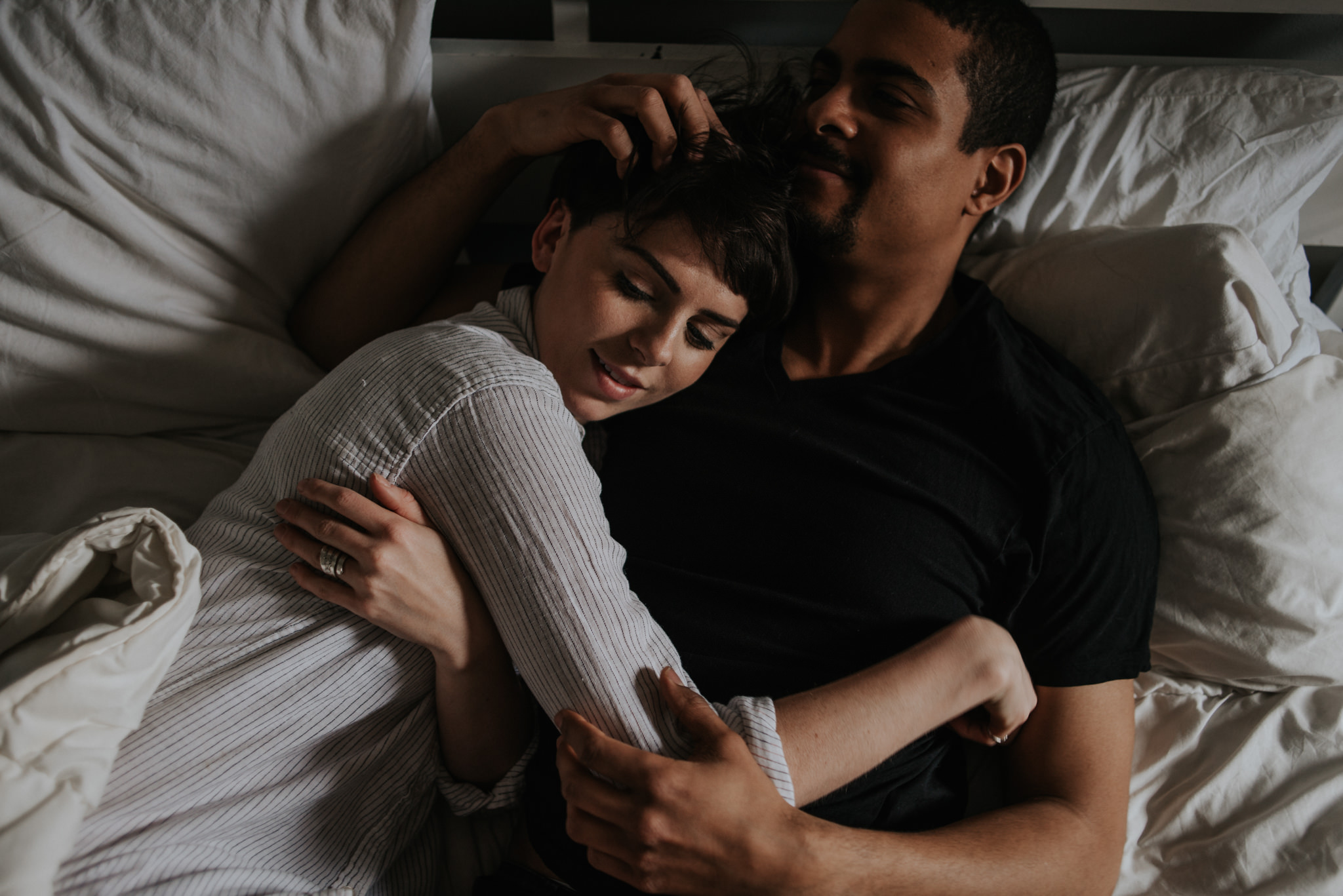 Young lovers lying in bed in bohemian apartment // Downtown Toronto Couple Shoot by Daring Wanderer