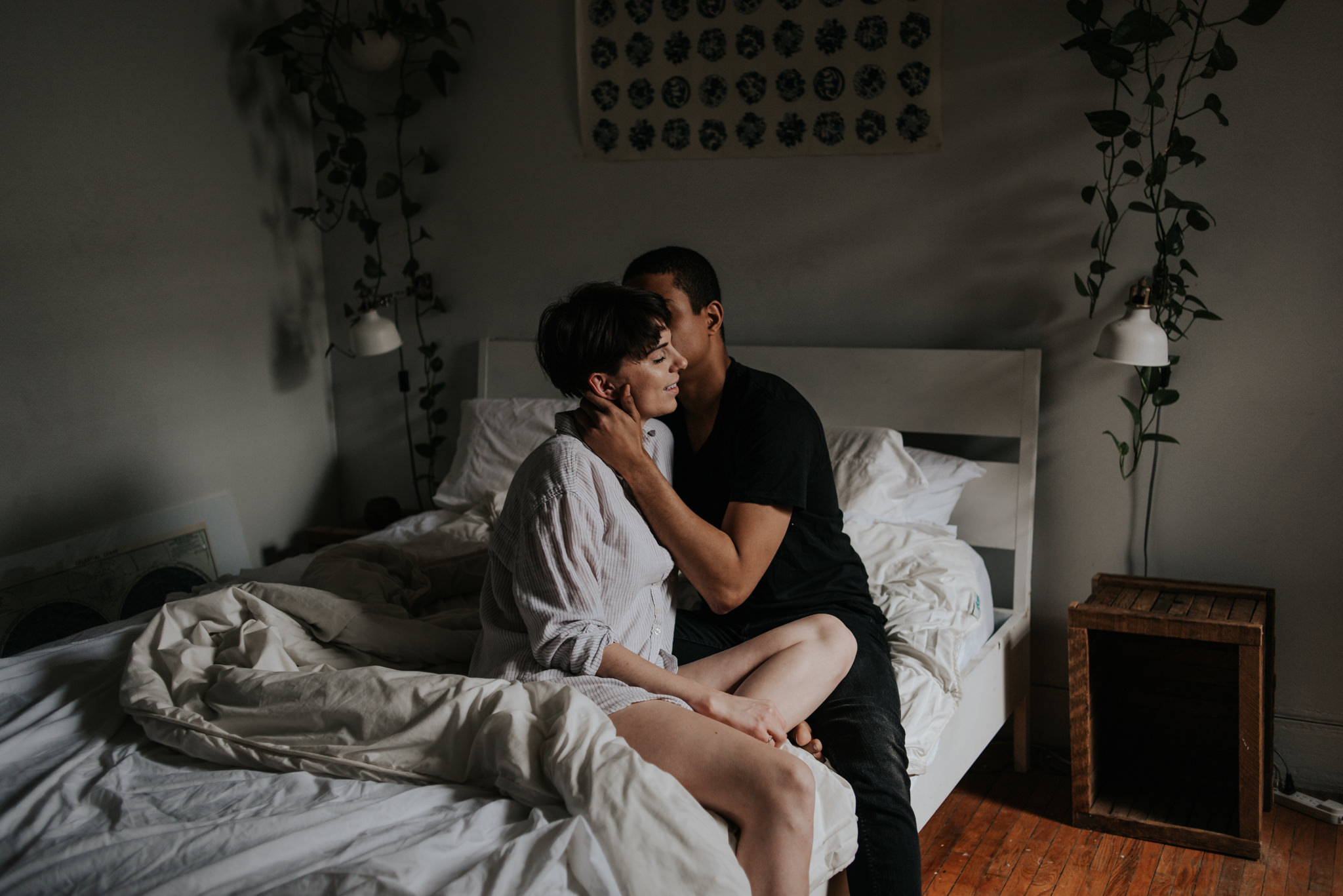 Young interracial couple sitting on bed in bohemian apartment // Downtown Toronto Couple Shoot by Daring Wanderer