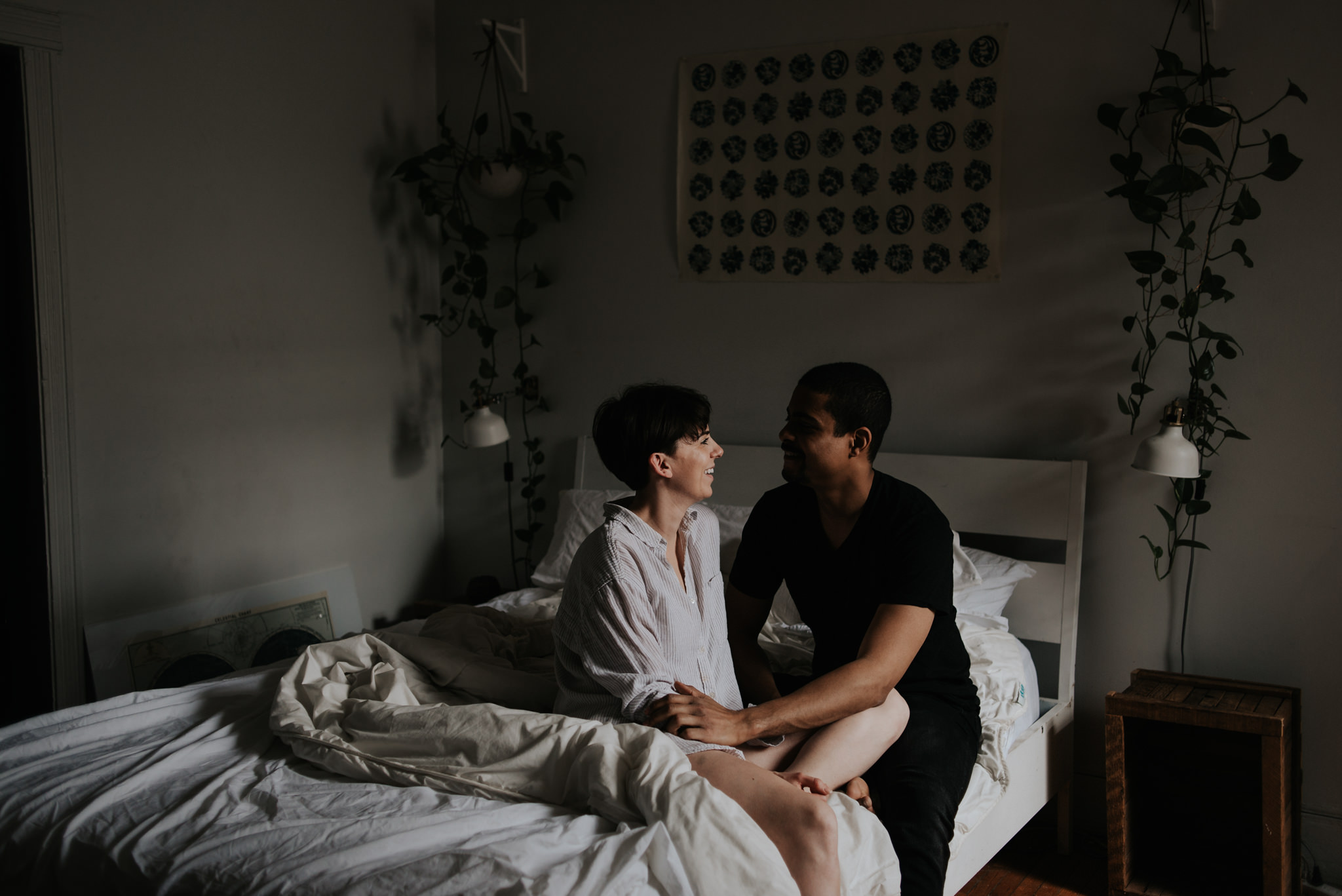 Young couple in love sitting on bed in bohemian apartment // Downtown Toronto Couple Shoot by Daring Wanderer