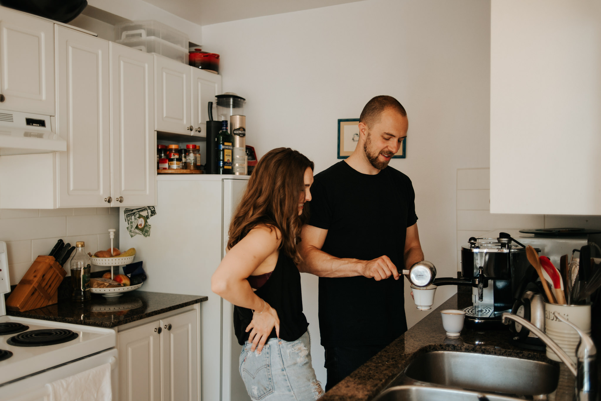 Couple making coffee in apartment kitchen