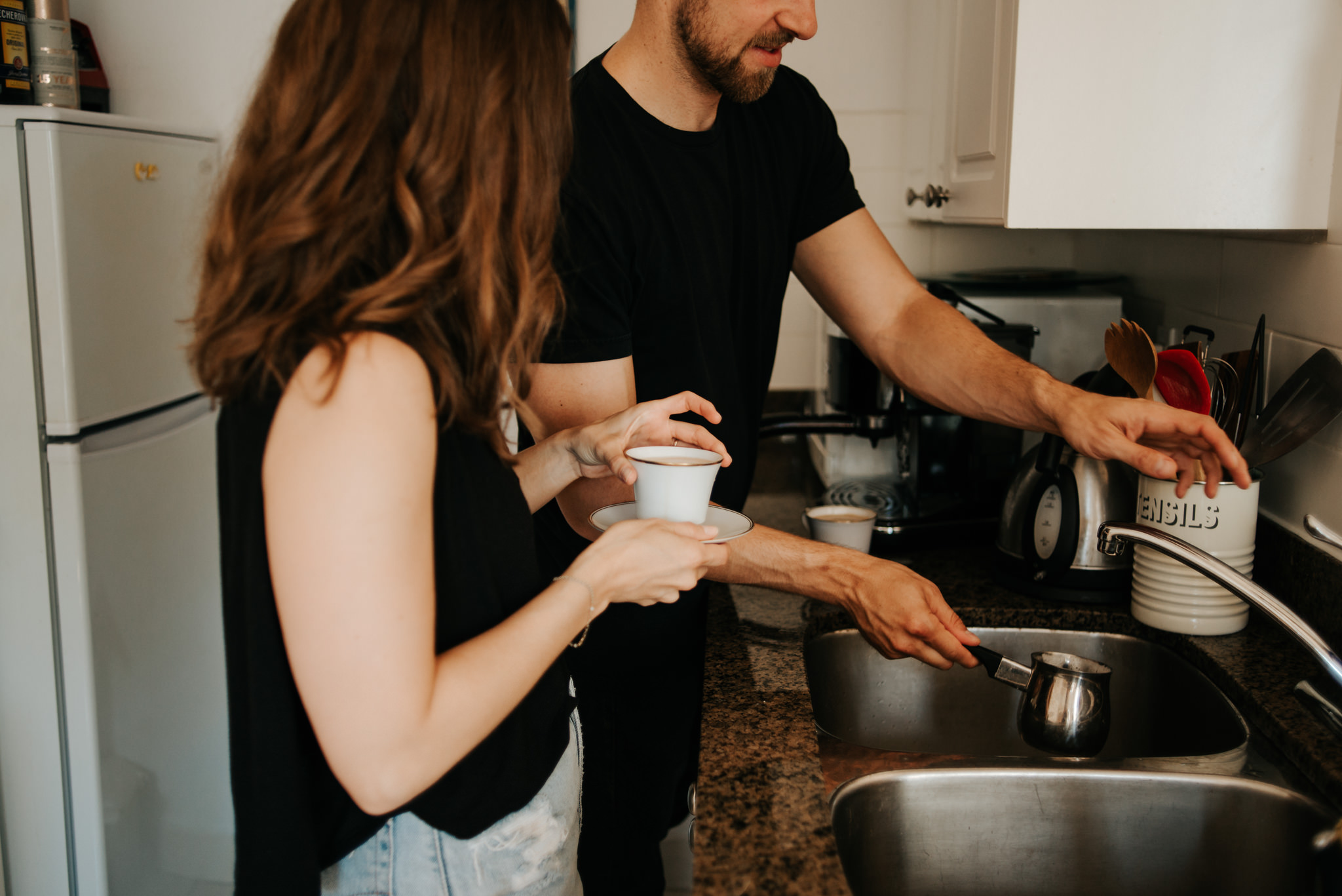 Couple making coffee in apartment kitchen