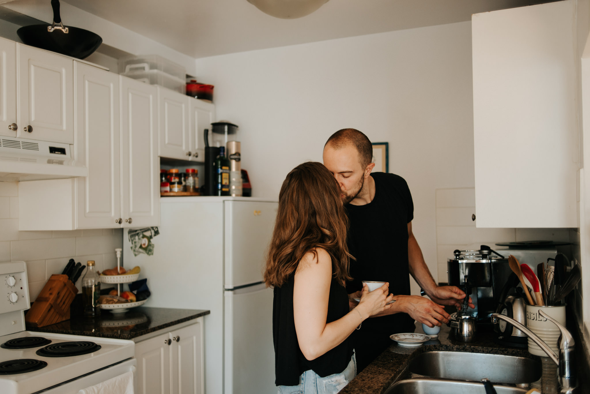 Couple kissing in apartment kitchen