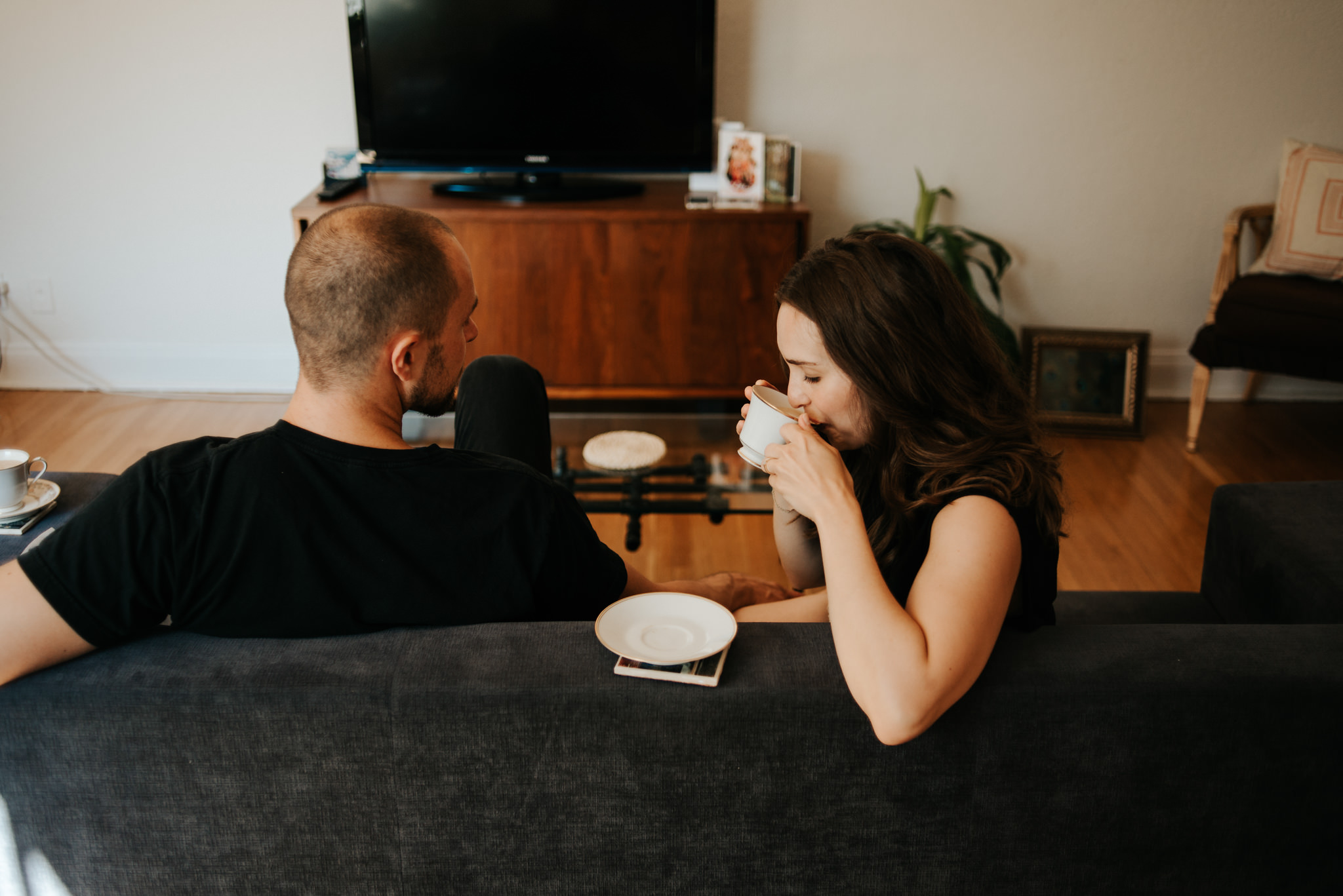 Couple sipping coffee on couch