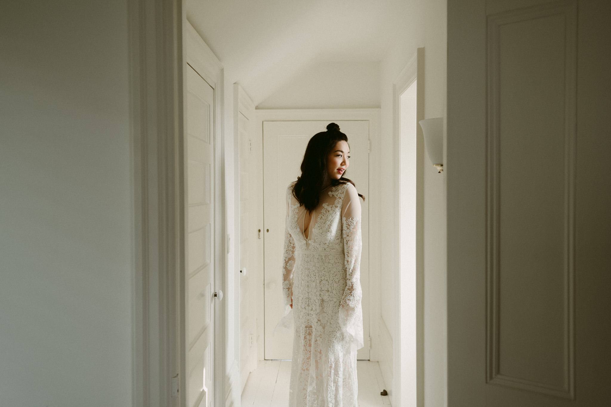 Groom waiting by window for bride