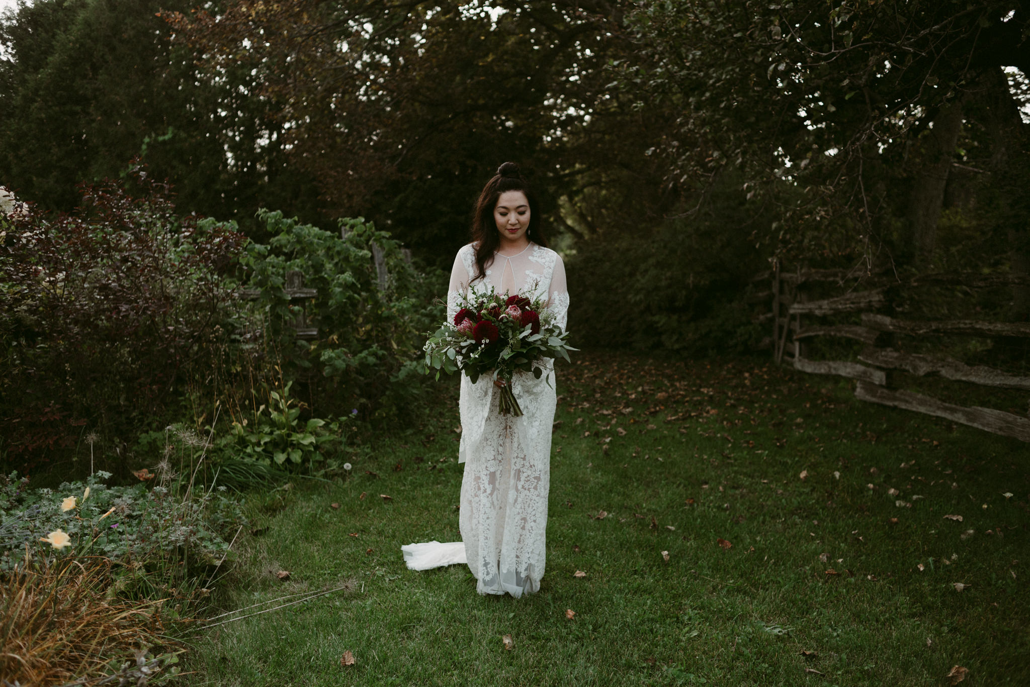 bride in garden holding bouquet