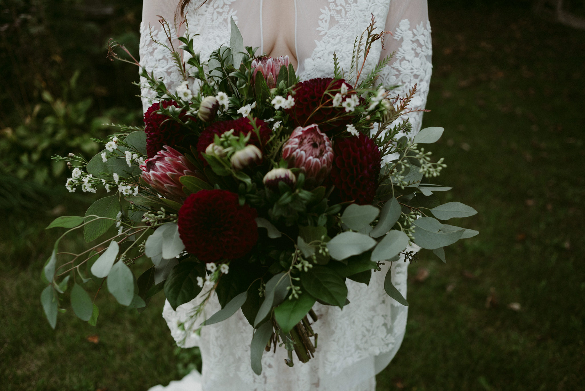 closeup of moody maroon and dark red wedding bouquet