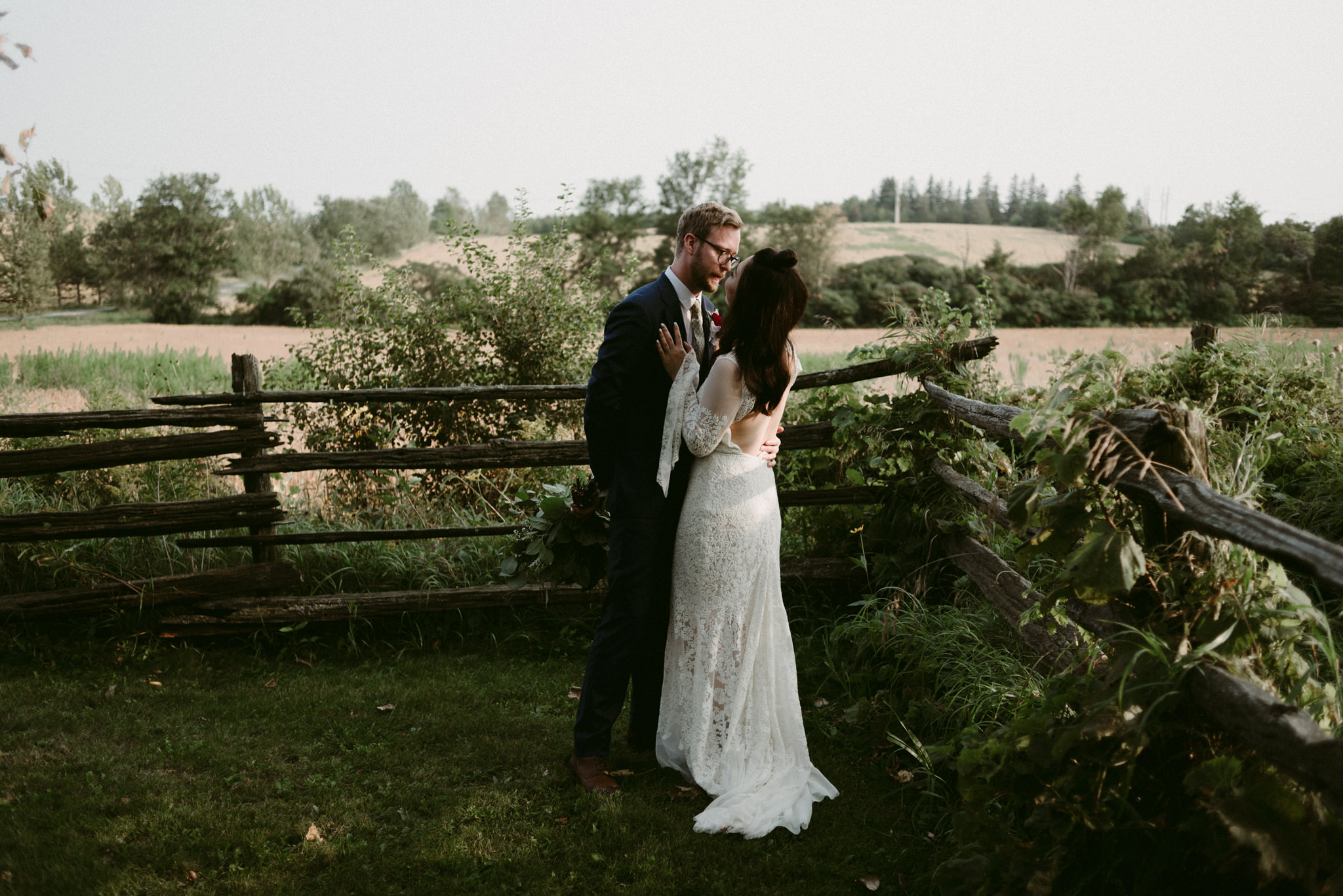 bride and groom hugging outside on farm