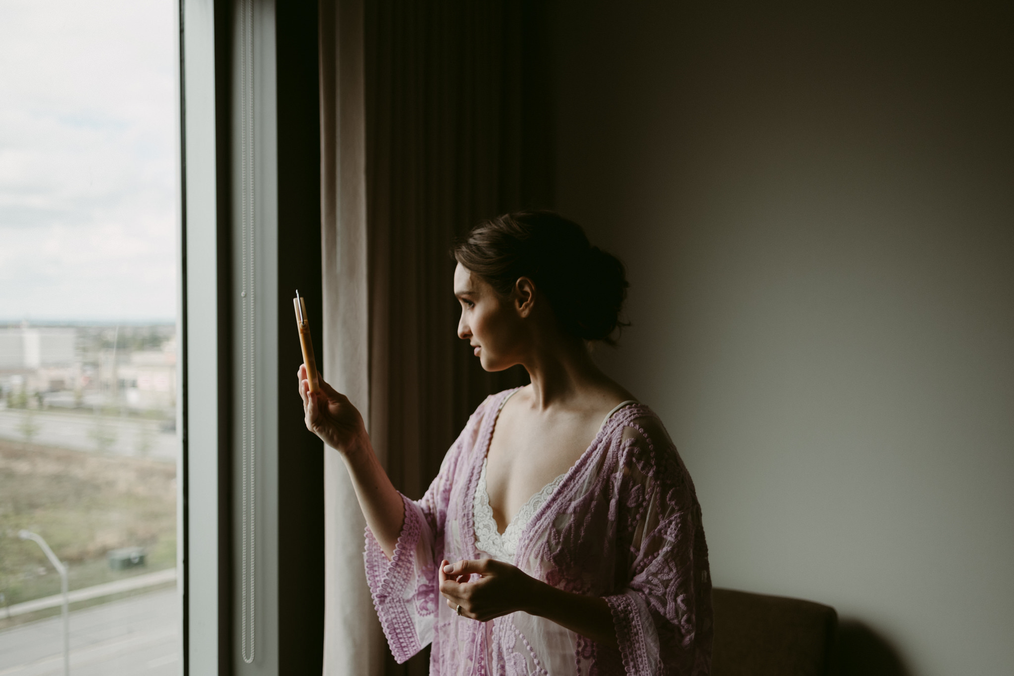 Bride looking at herself in mirror in hotel