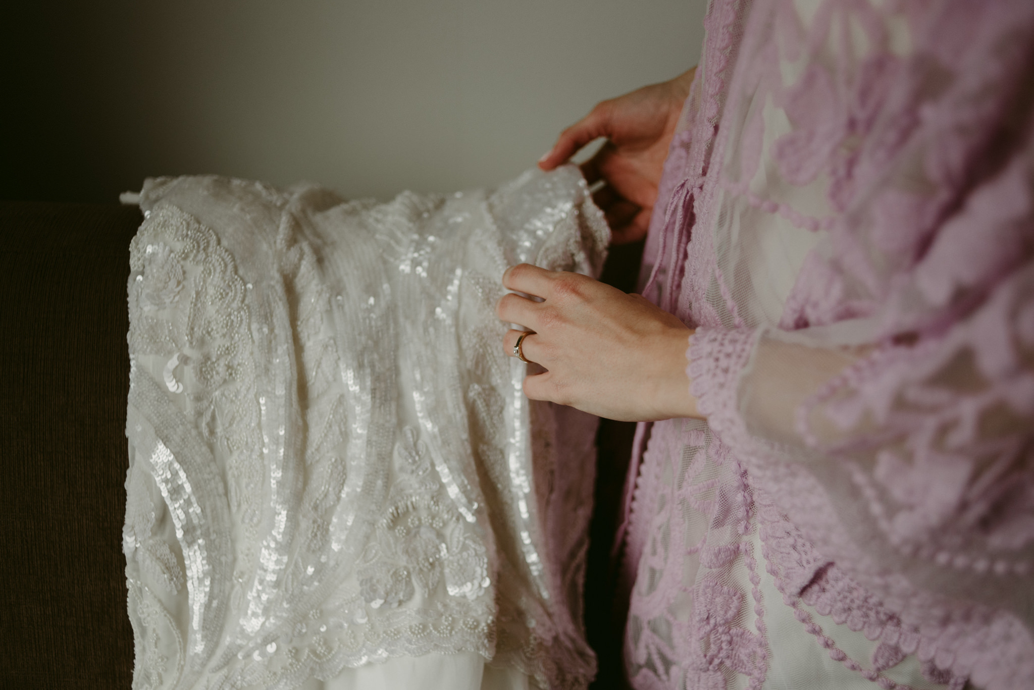 Bride touching wedding dress