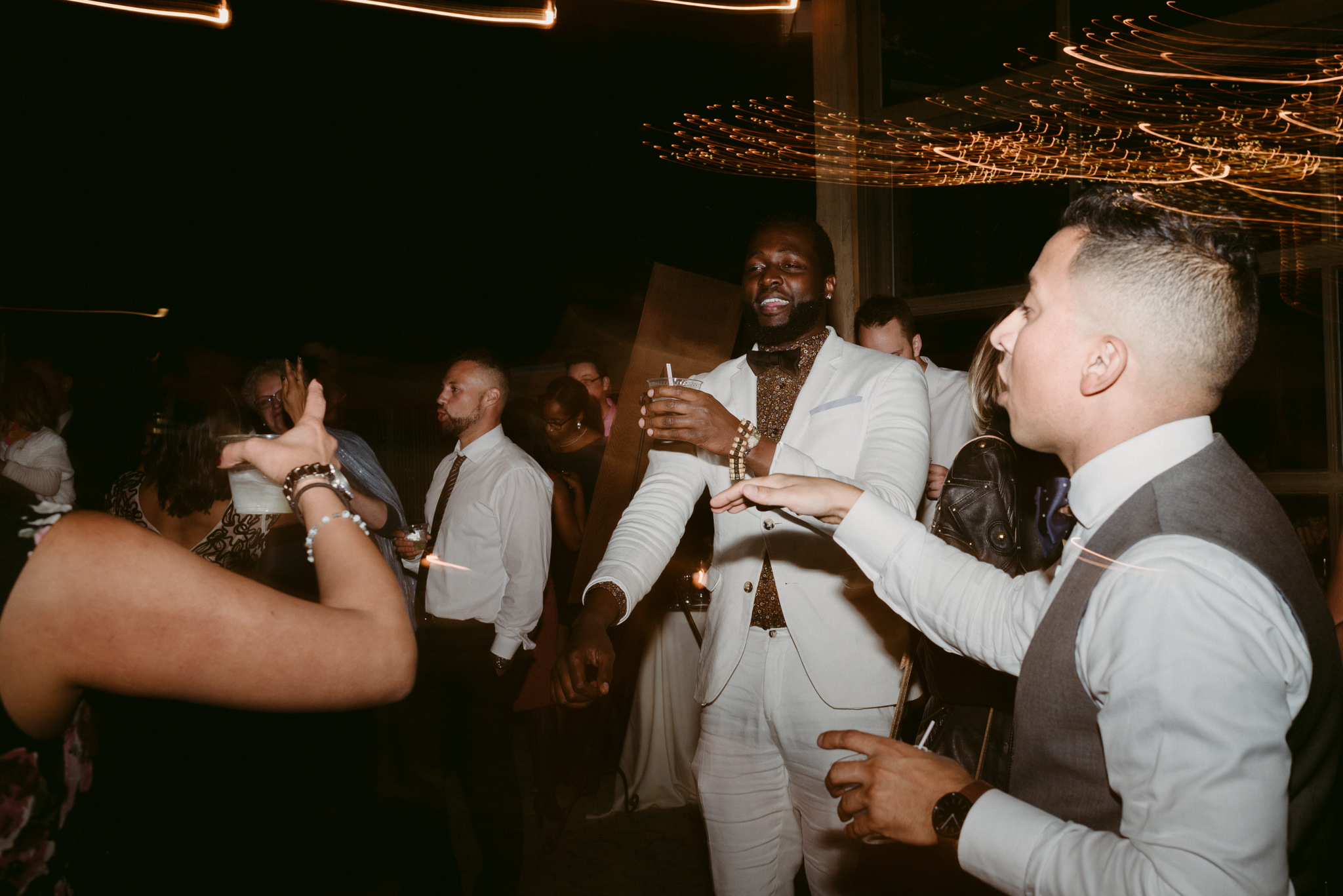 Guests drinking and dancing during reception dancing