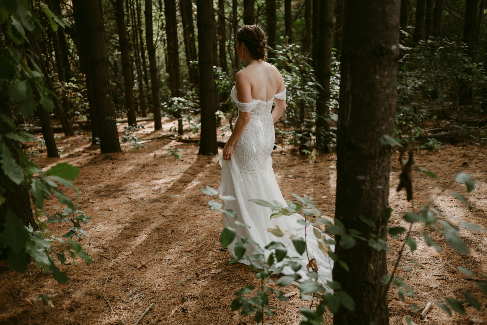 Bride walking in forest at Kortright Centre for Conservation