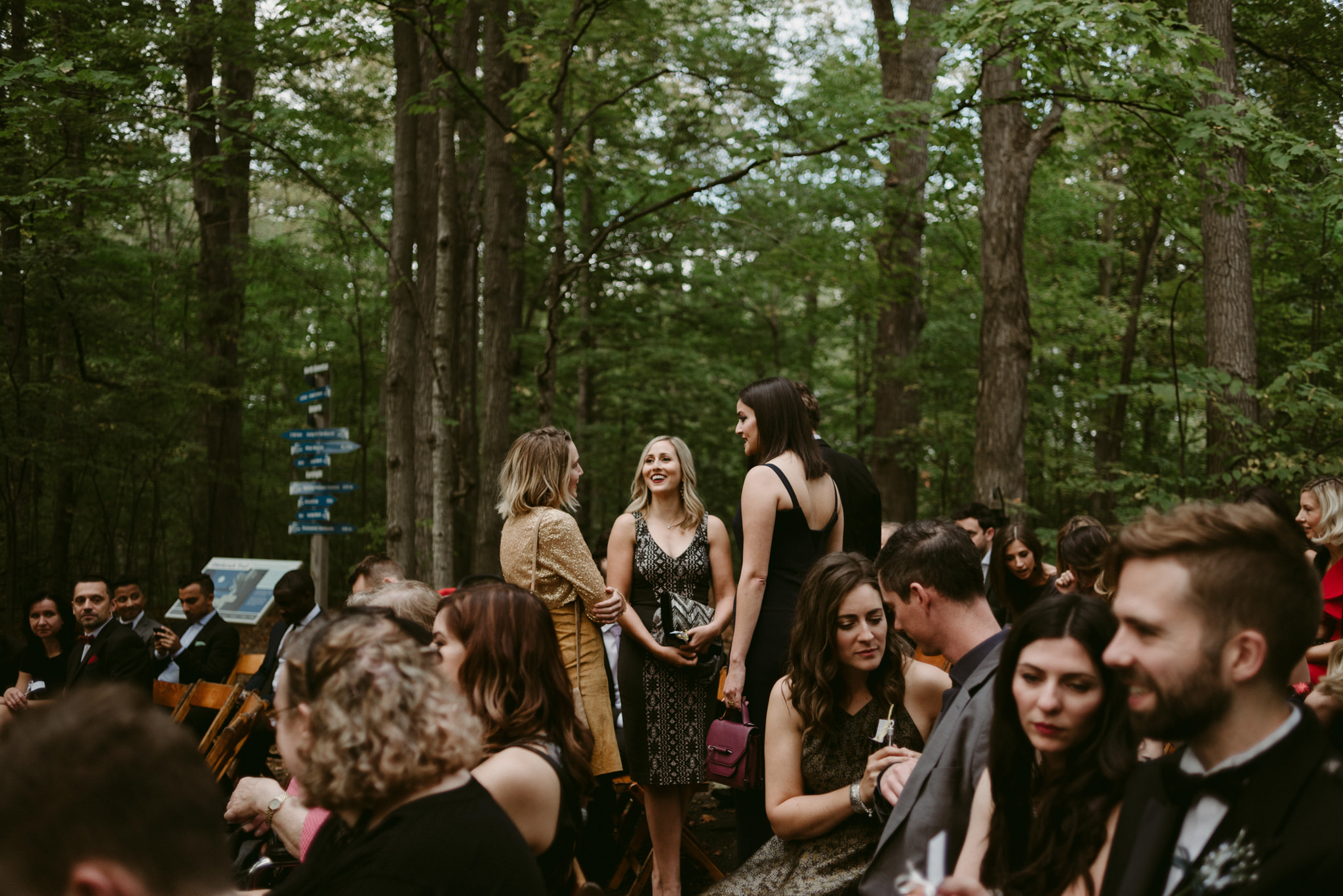 Guests waiting for ceremony to start in forest