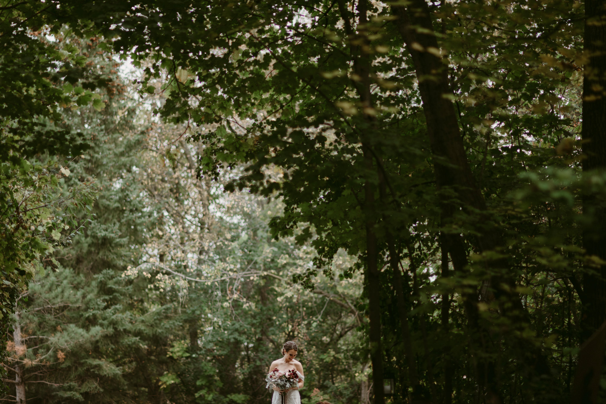 Bride waiting to walk down aisle in forest wedding ceremony