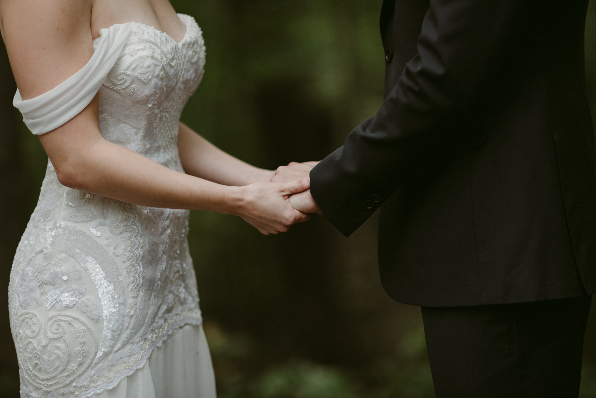 Bride and groom holding hands during ceremony