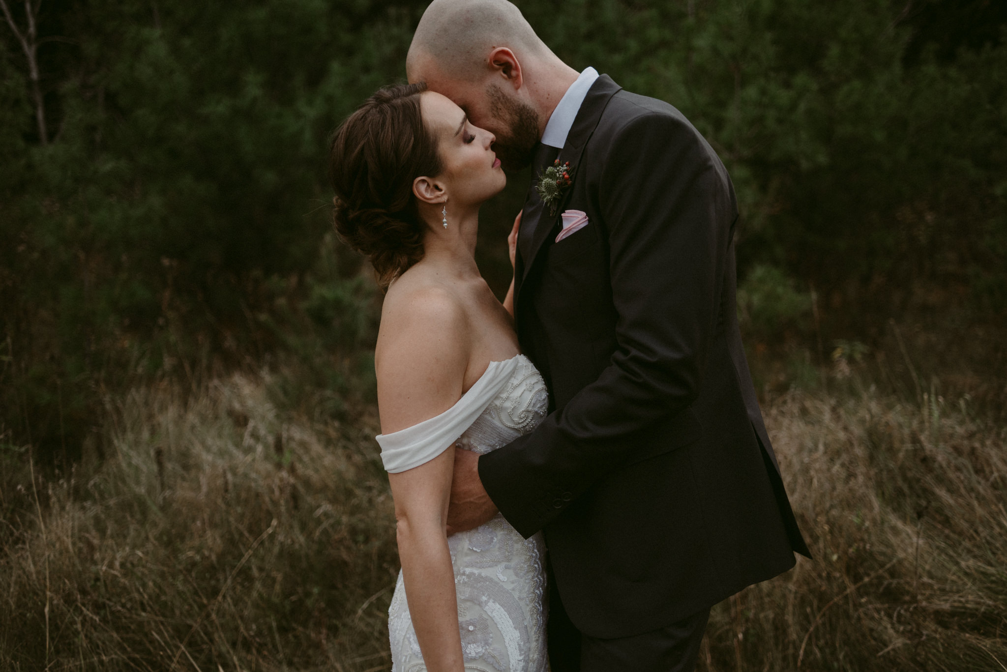 Groom whispering in bride's ear