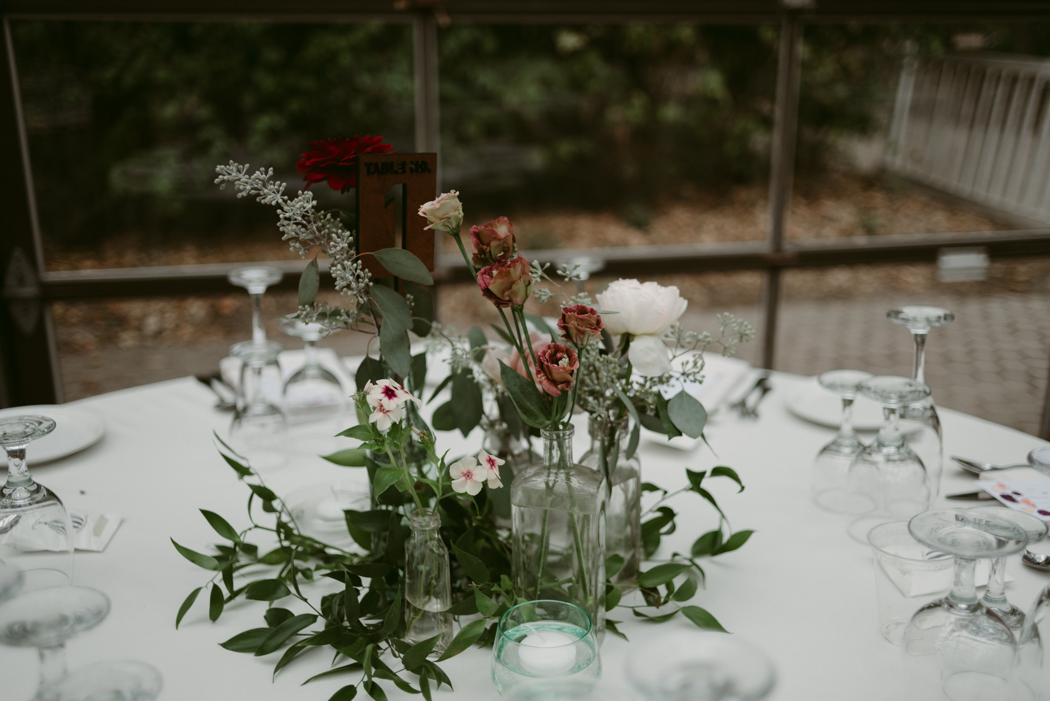 Flowers in glass vases for table centrepiece at wedding reception