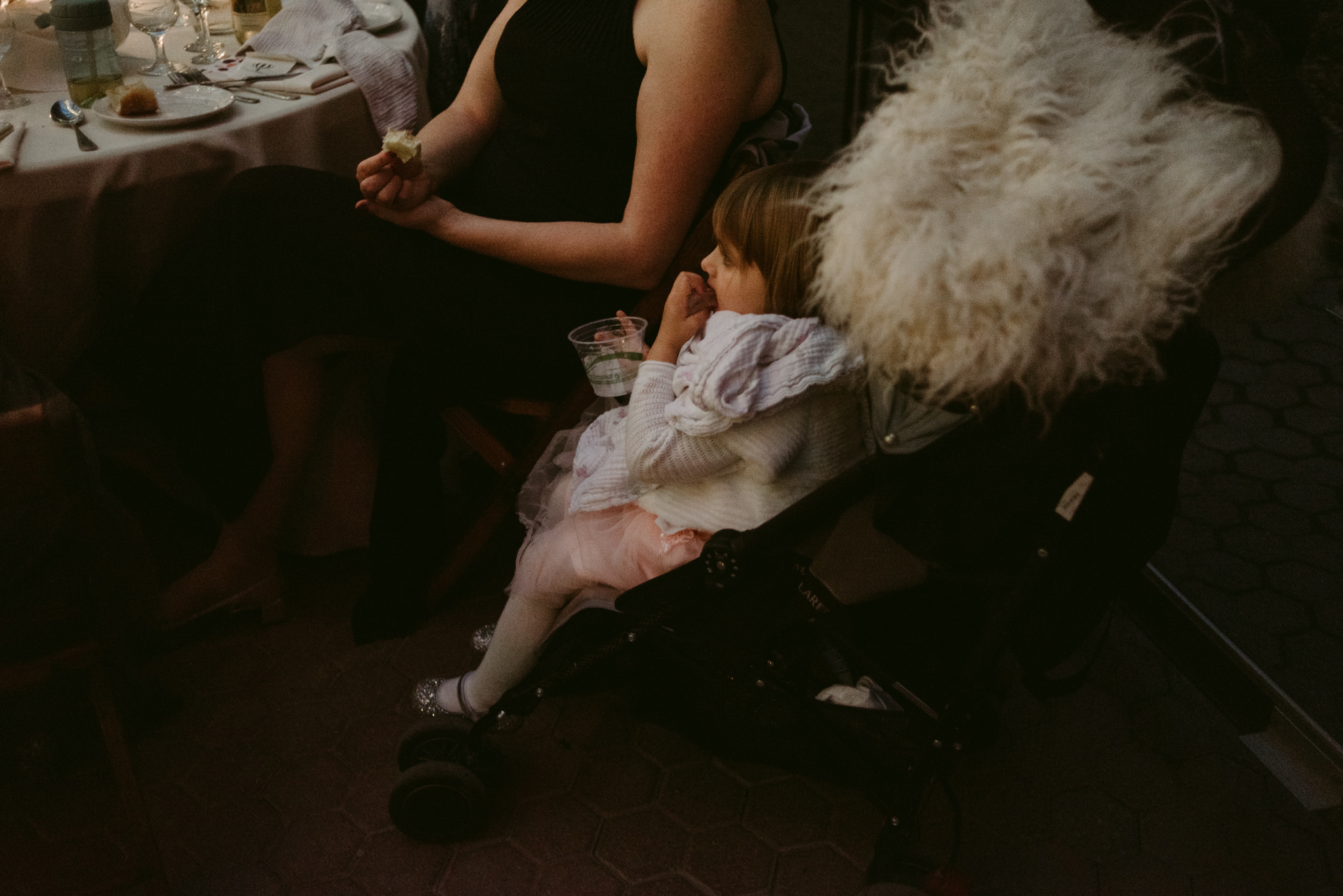 Little girl in stroller at wedding reception
