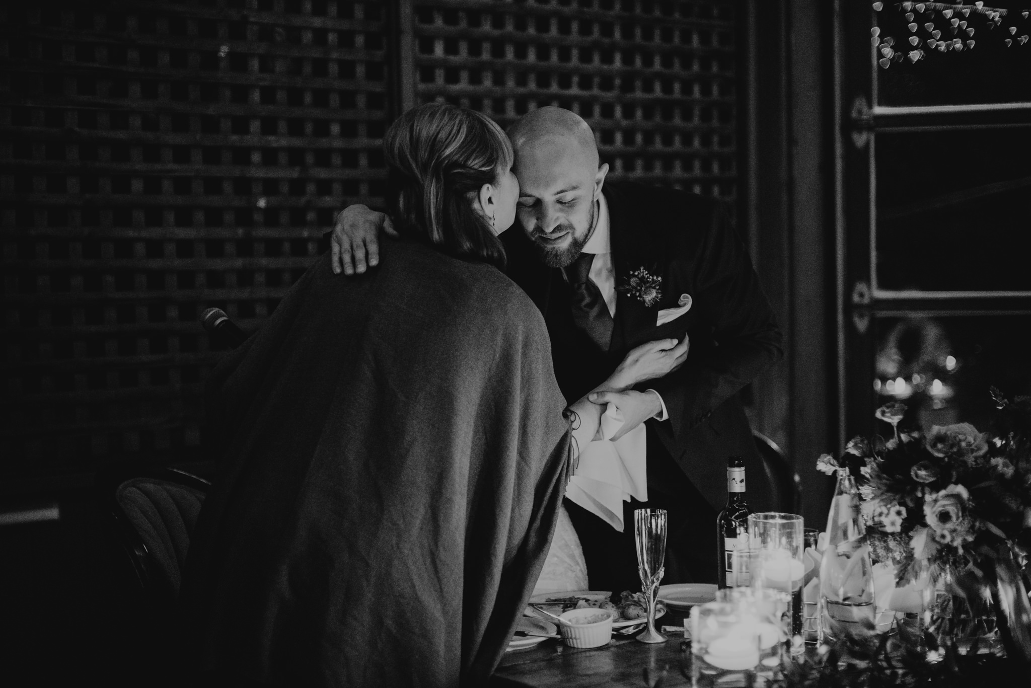 groom hugging mother at wedding reception