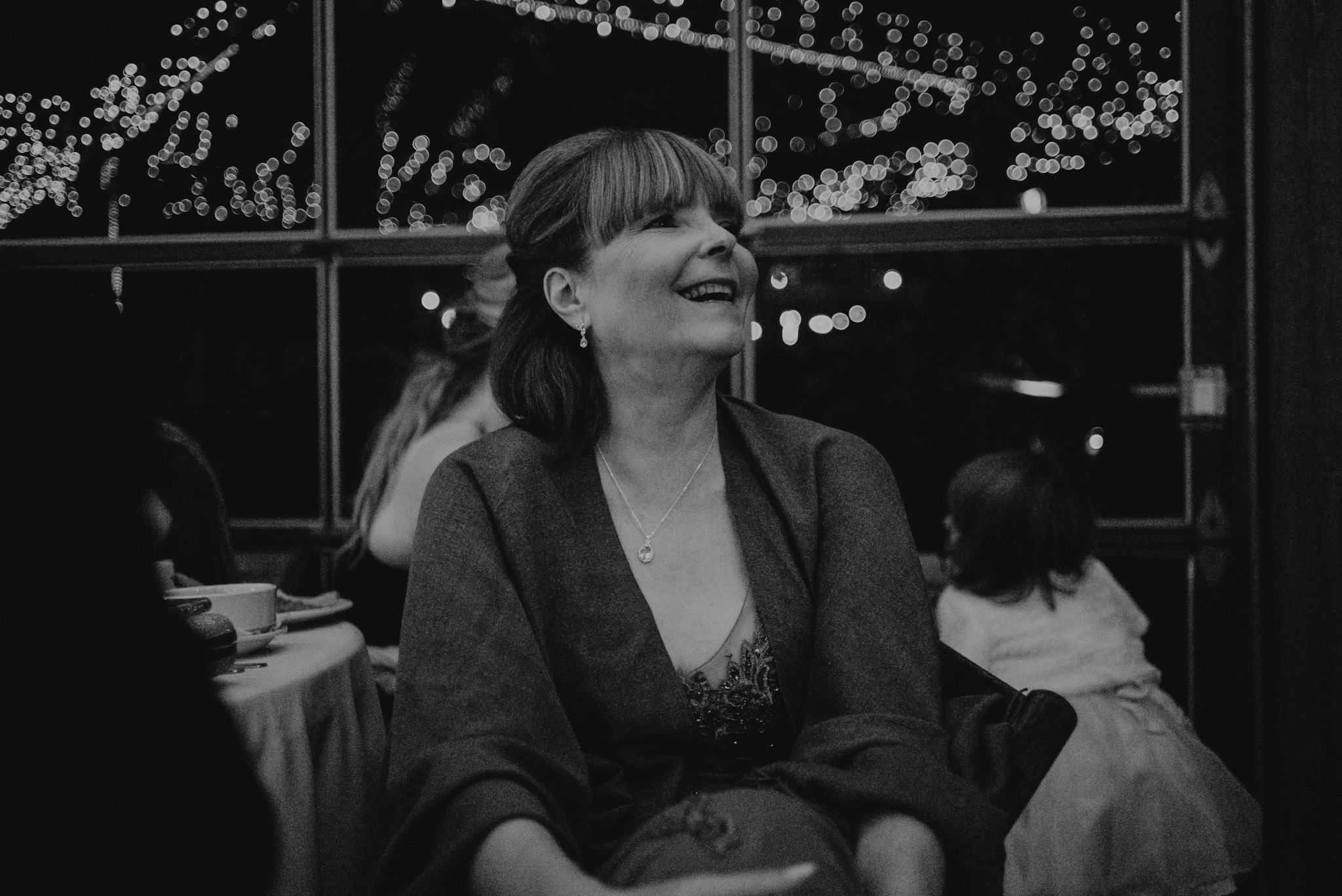 Mother of bride listening to speeches at wedding