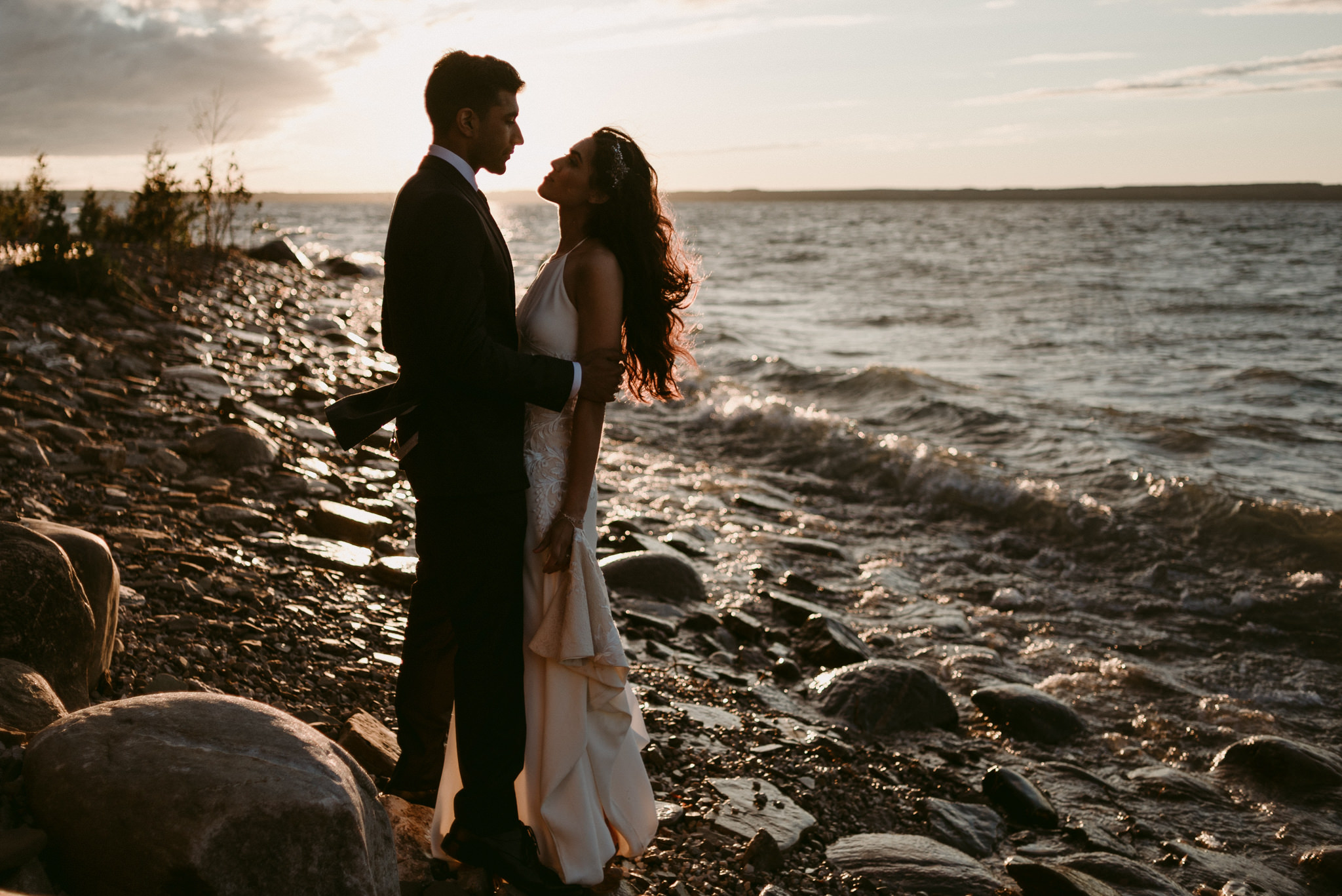 bride and groom by water at sunset on georgian bay