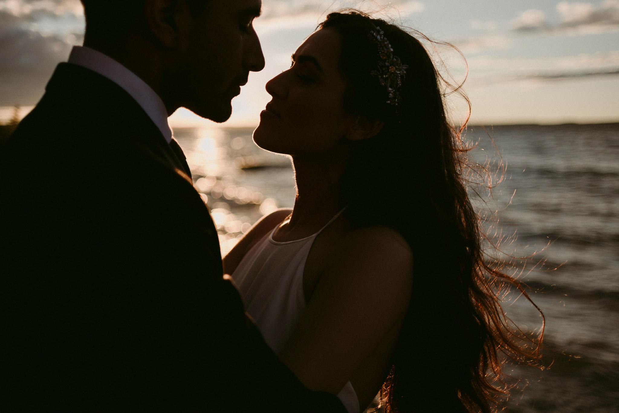 bride and groom by water at sunset on georgian bay