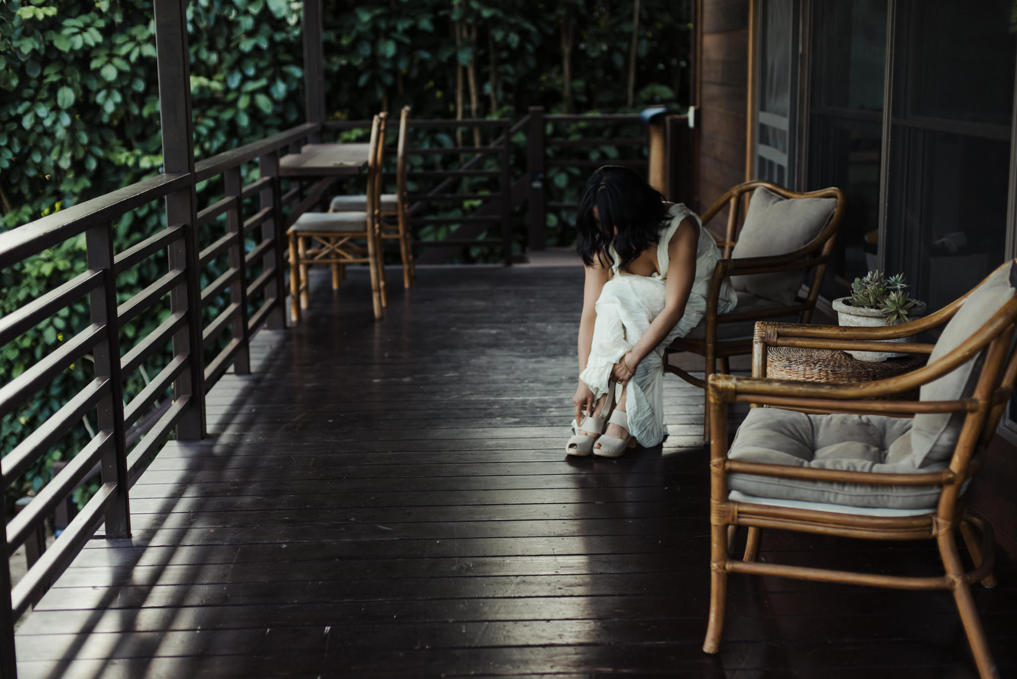 bride putting on shoes on patio outdoors