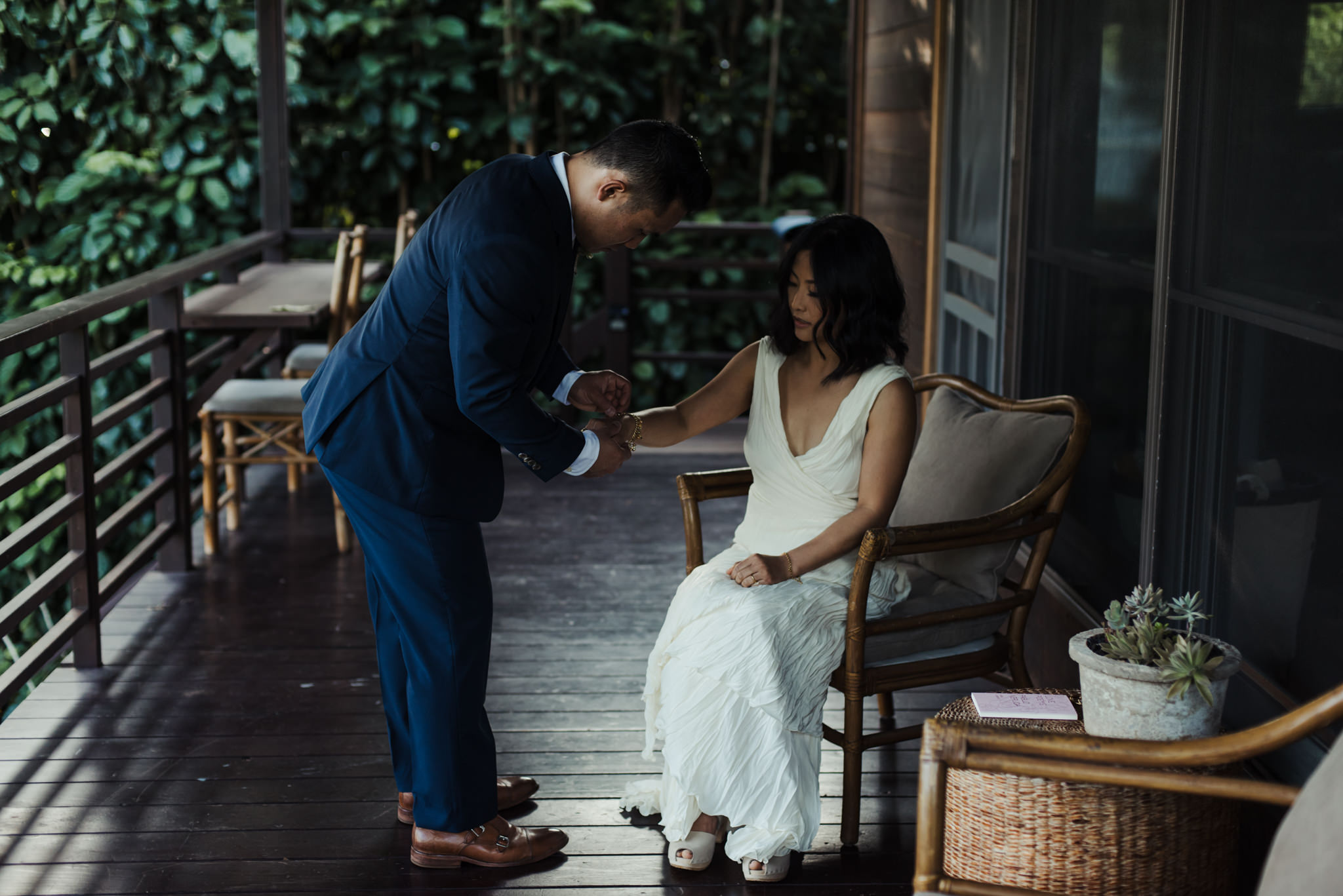 groom putting on brides bracelet