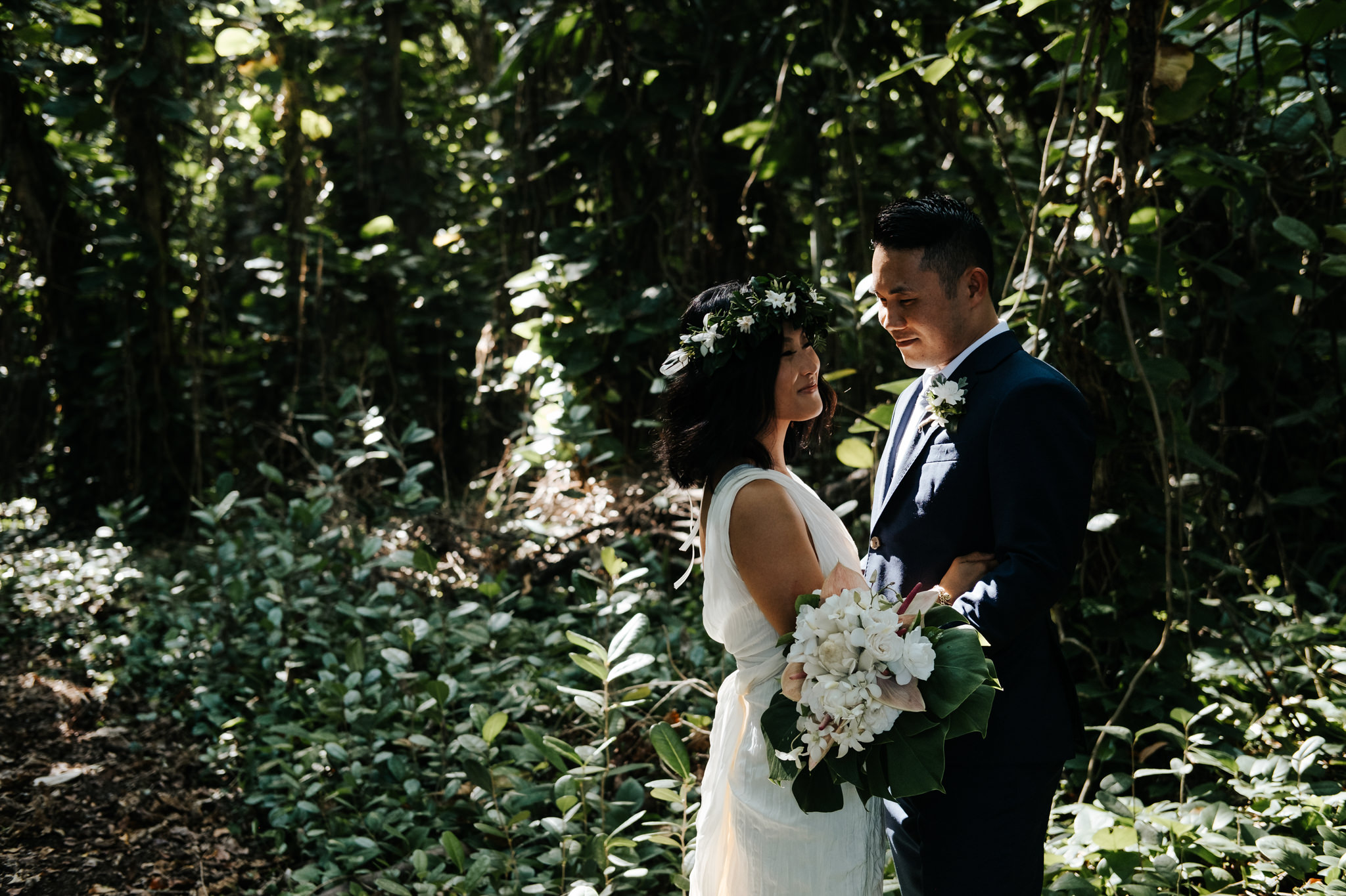 bride and groom walking in tropical forest