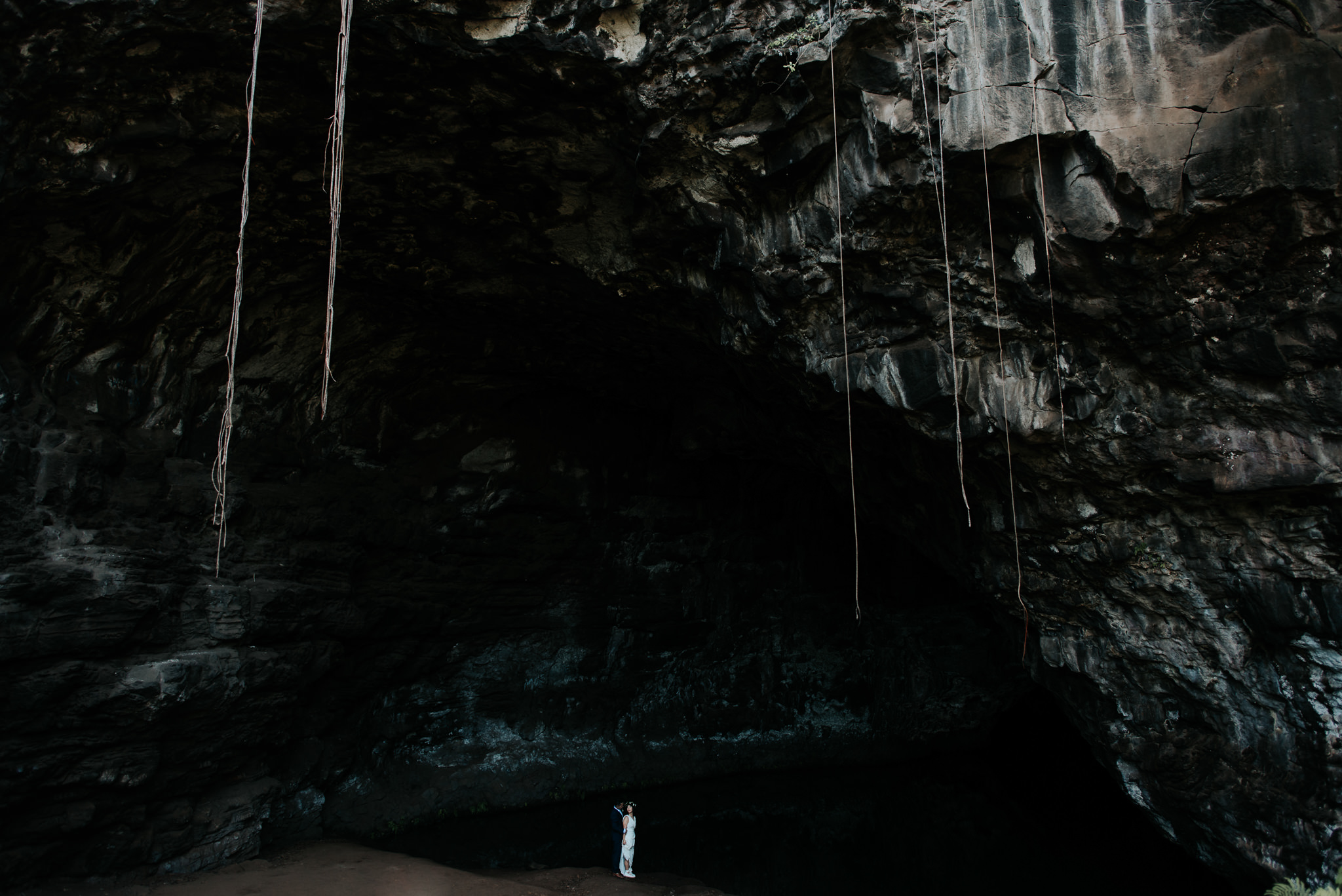 bride and groom in cave in kauai