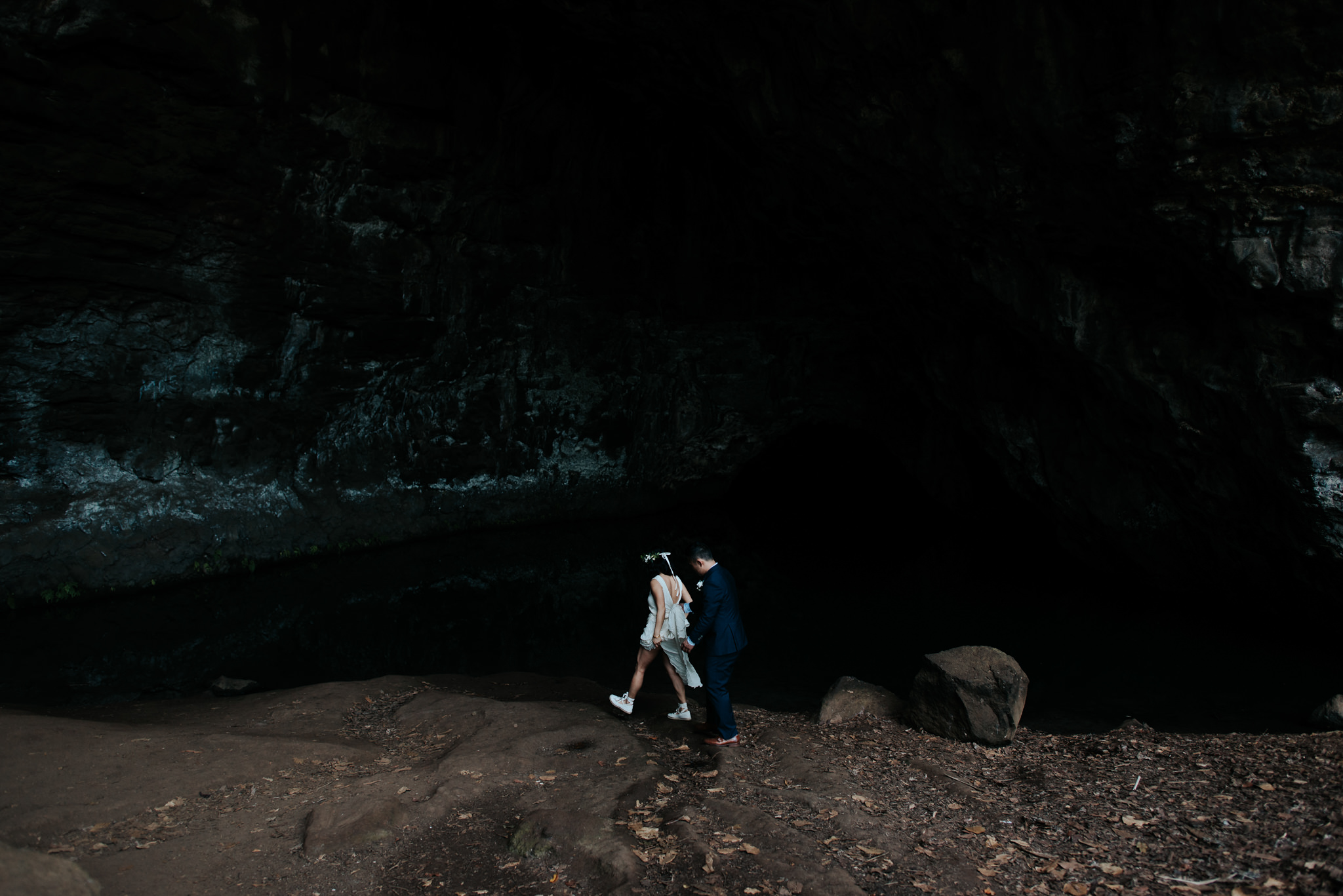 bride and groom in cave in kauai