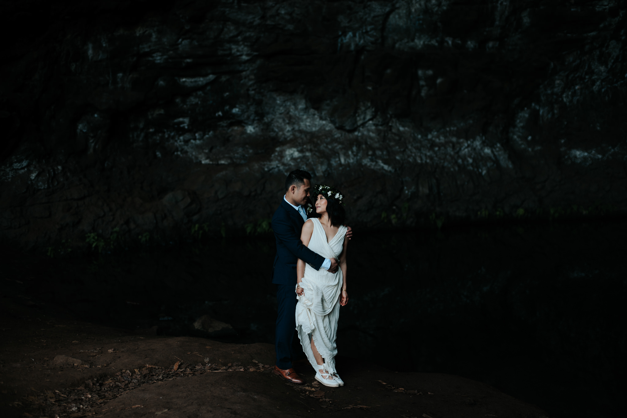 bride and groom in cave in kauai