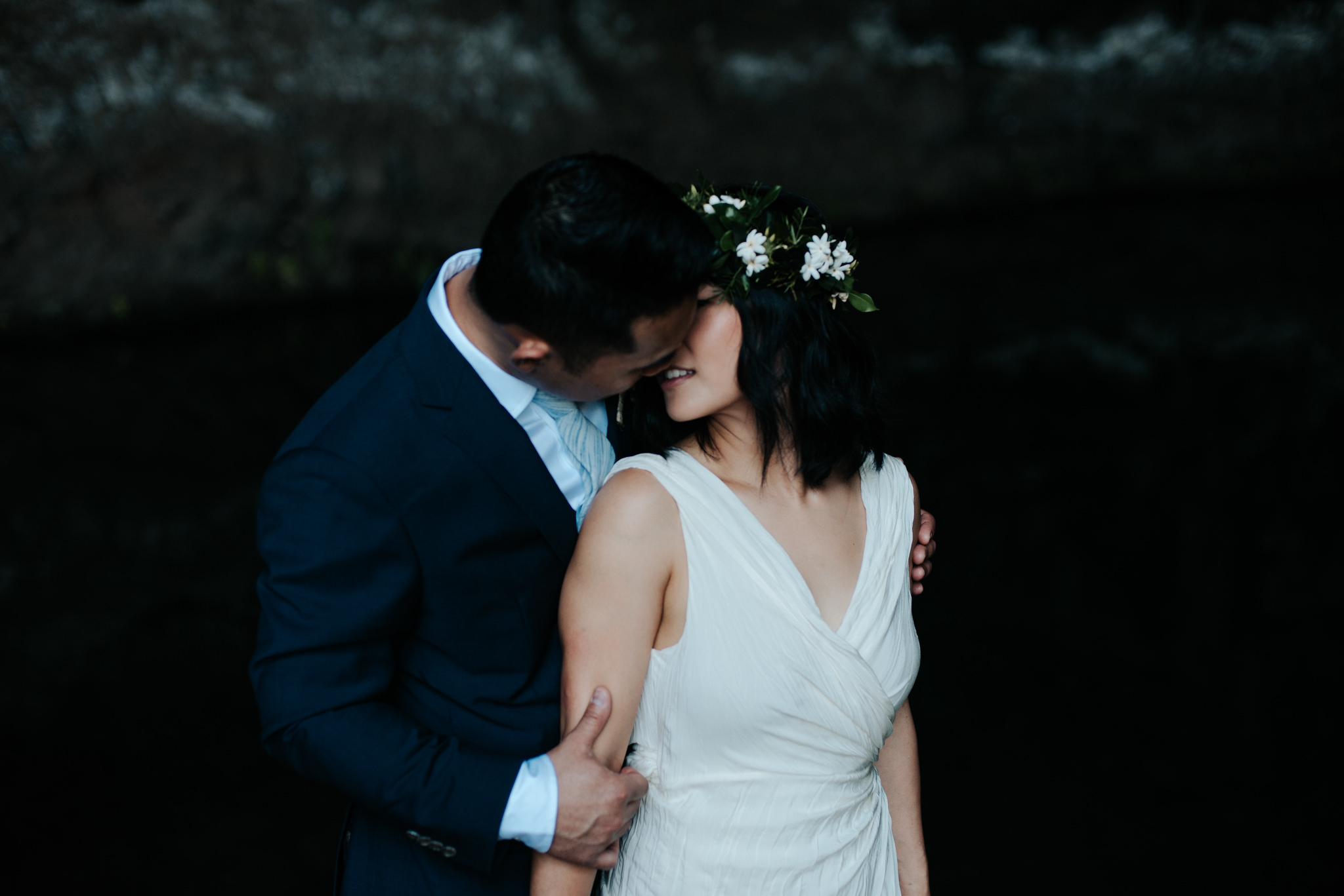 bride and groom in cave in kauai