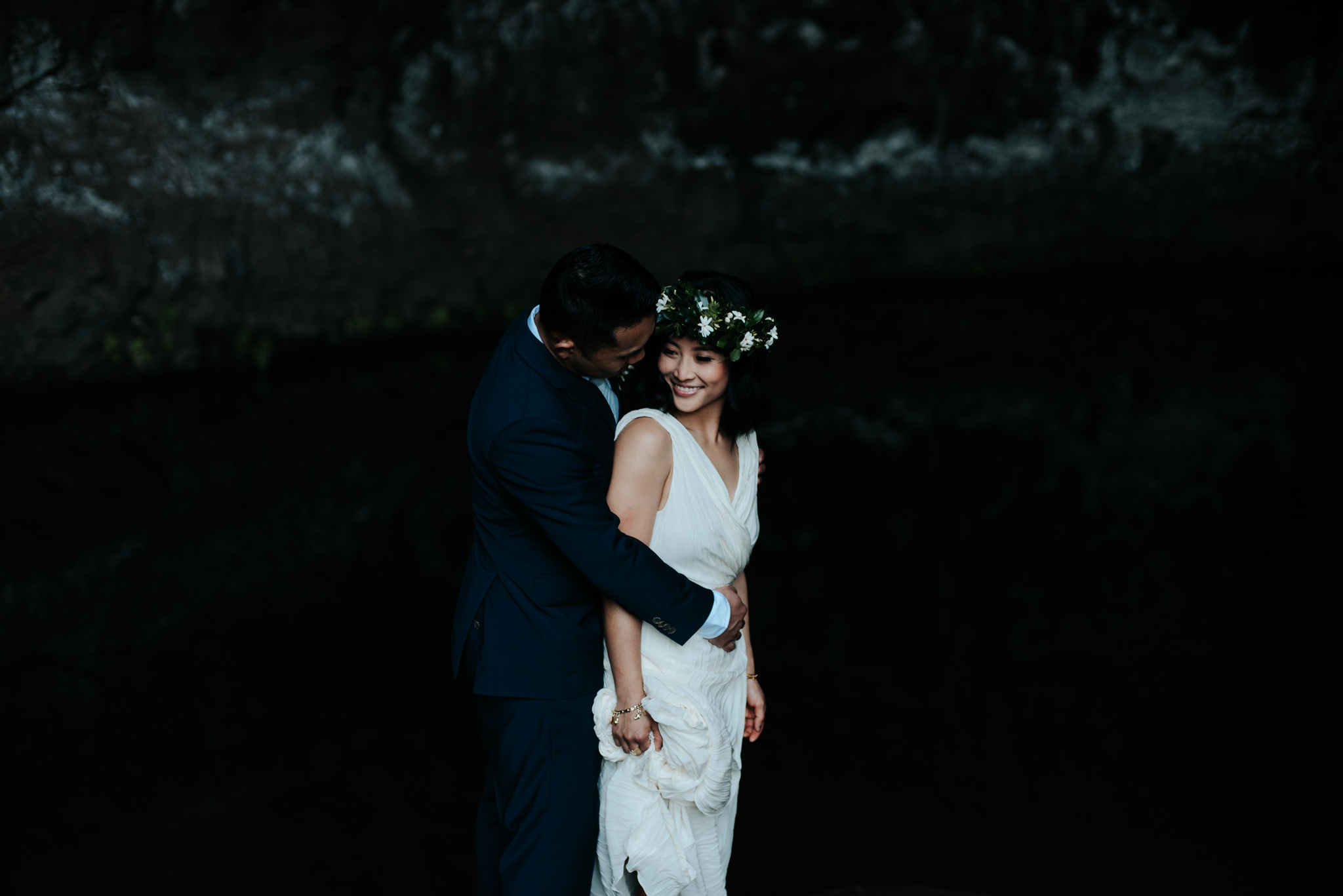 bride and groom in cave in kauai