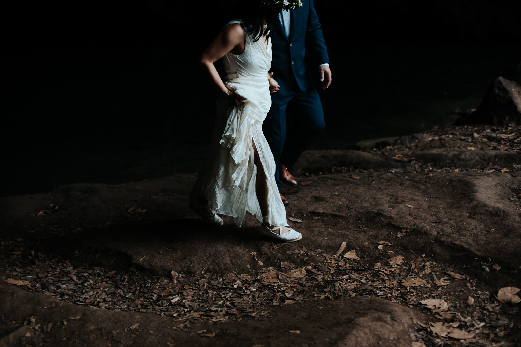 bride and groom in cave in kauai