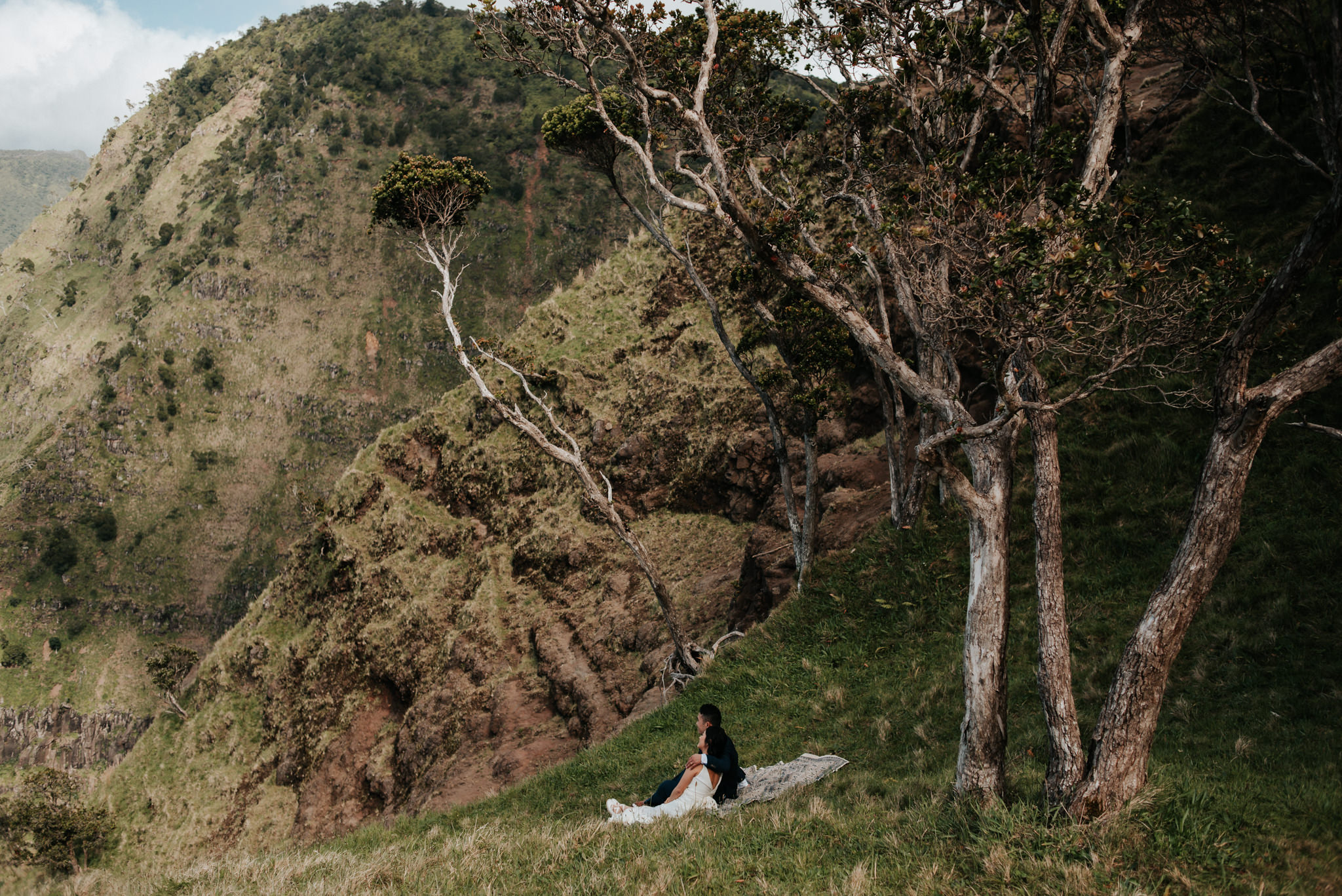 bride and groom having picnic with view of Na pali Coast Kauai