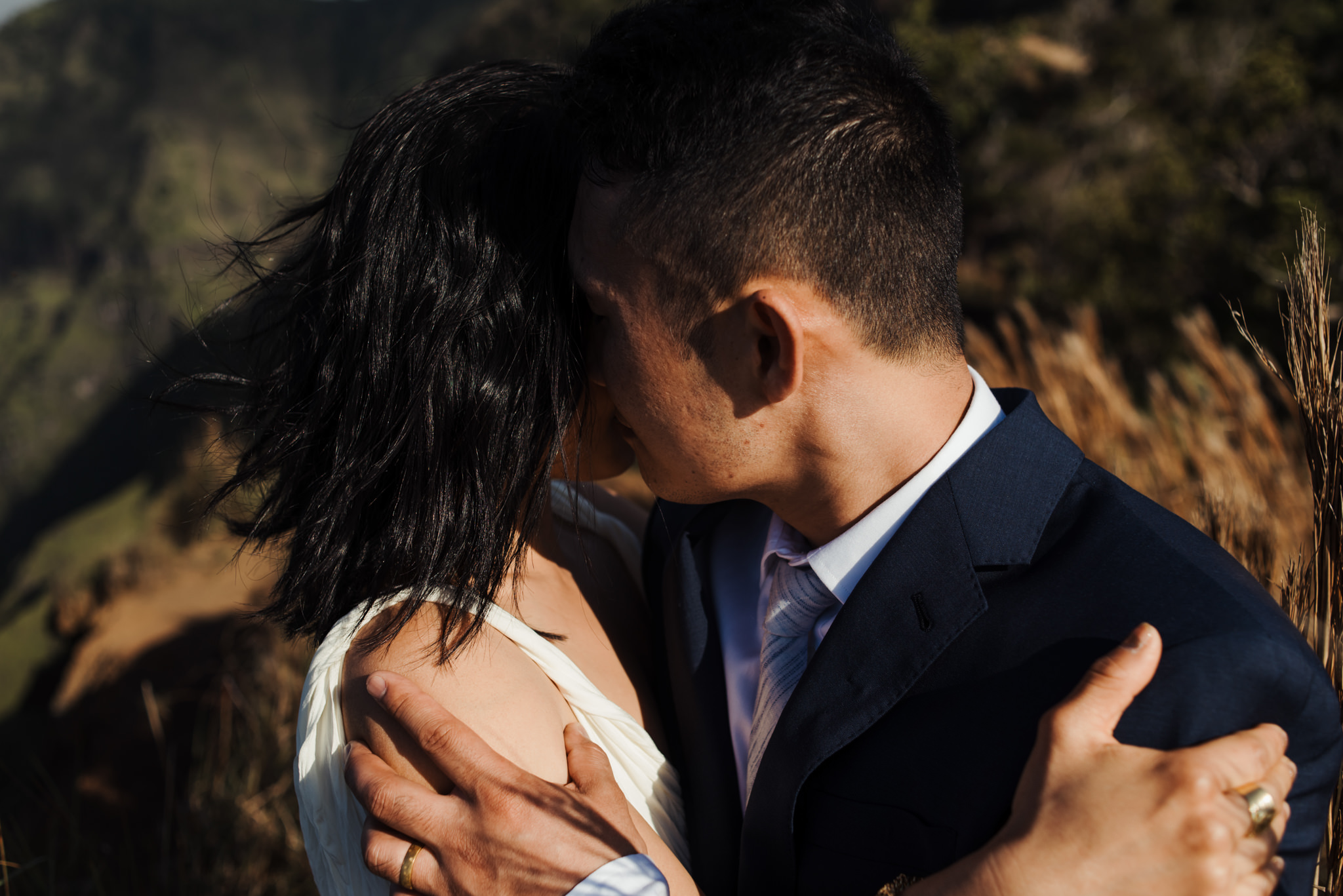 bride and groom kissing in sunlight in Kauai