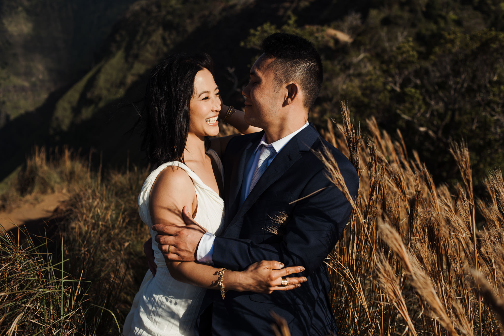 bride and groom laughing at sunset in Kauai