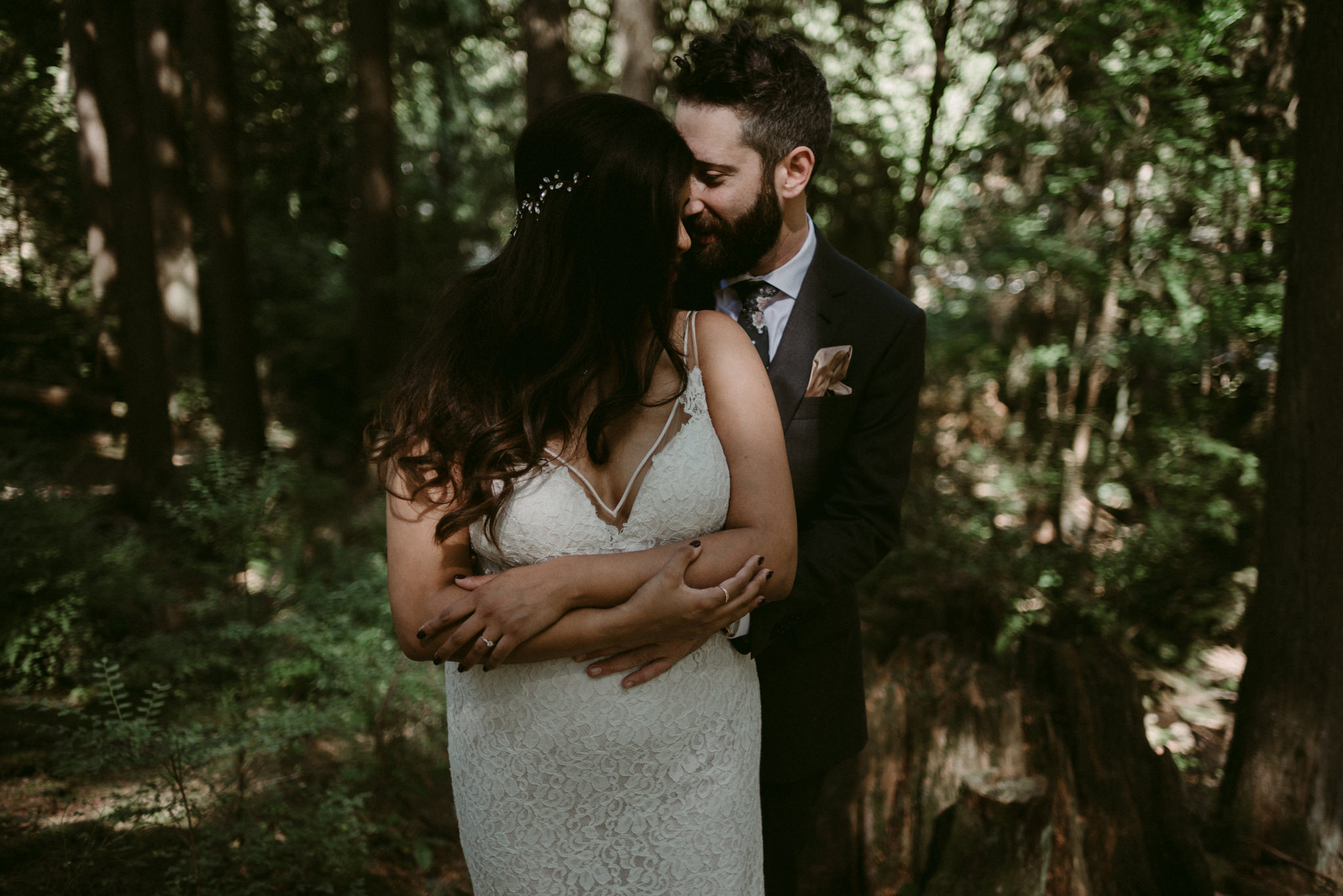 groom hugging bride from behind