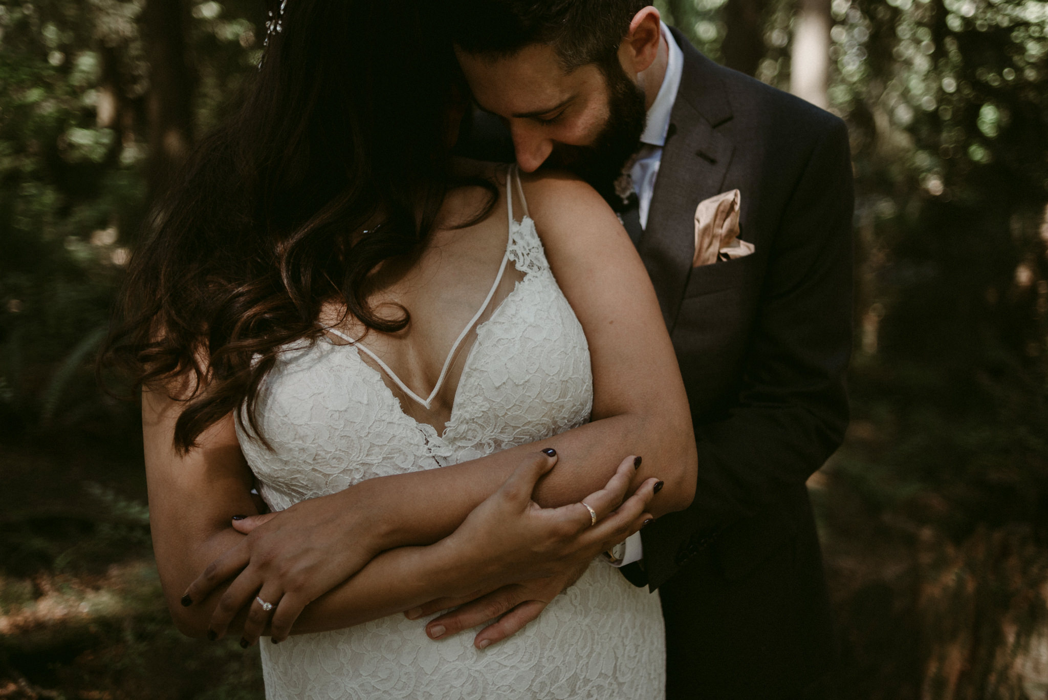 groom kissing brides shoulder