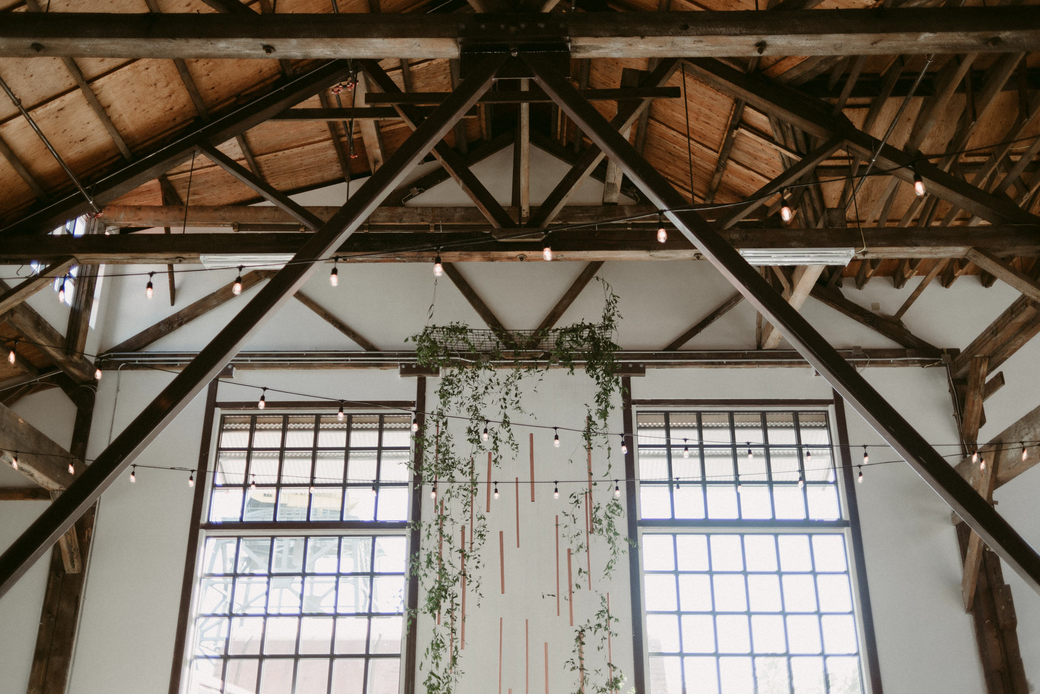 tall copper and vine backdrop installation at Pipe Shop wedding venue