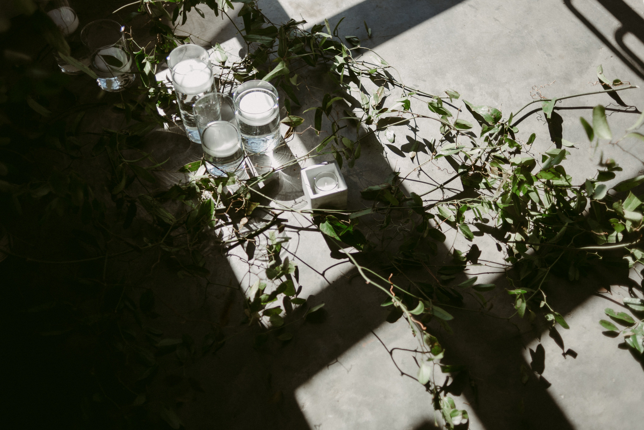 candles and vines on concrete floor