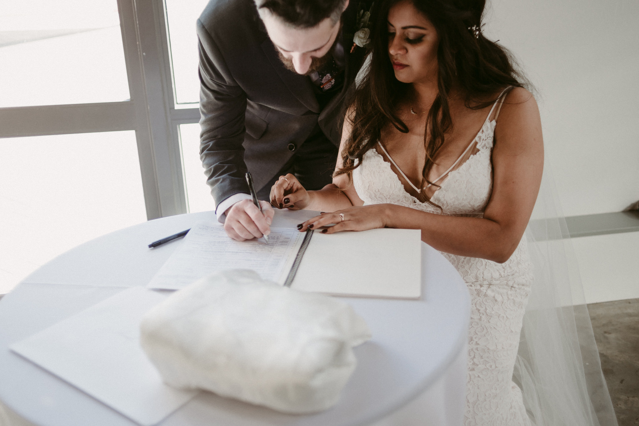 bride and groom signing marriage license