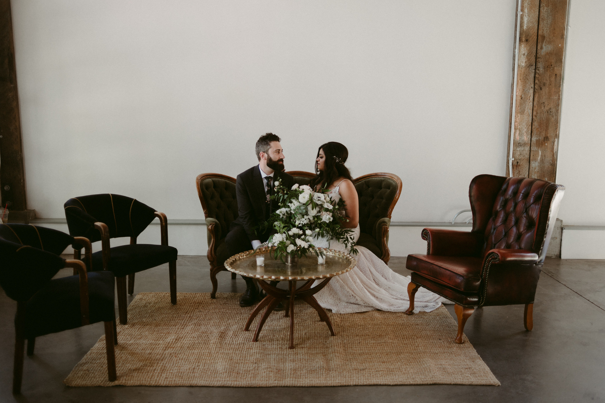 couple sitting on couch on wedding day