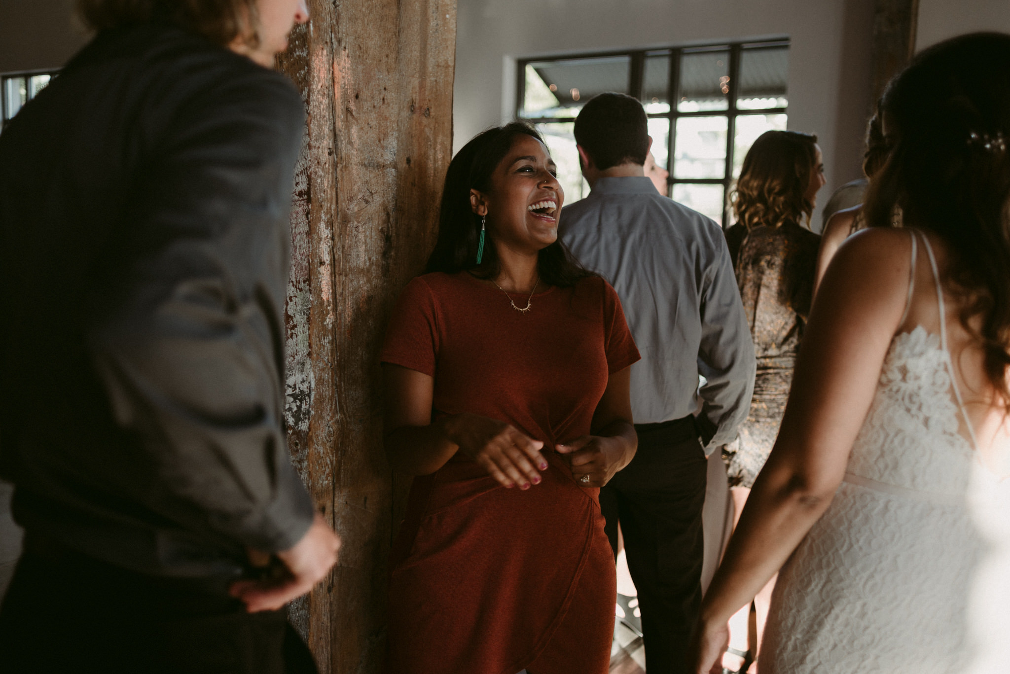 guests laughing during cocktail hour at wedding