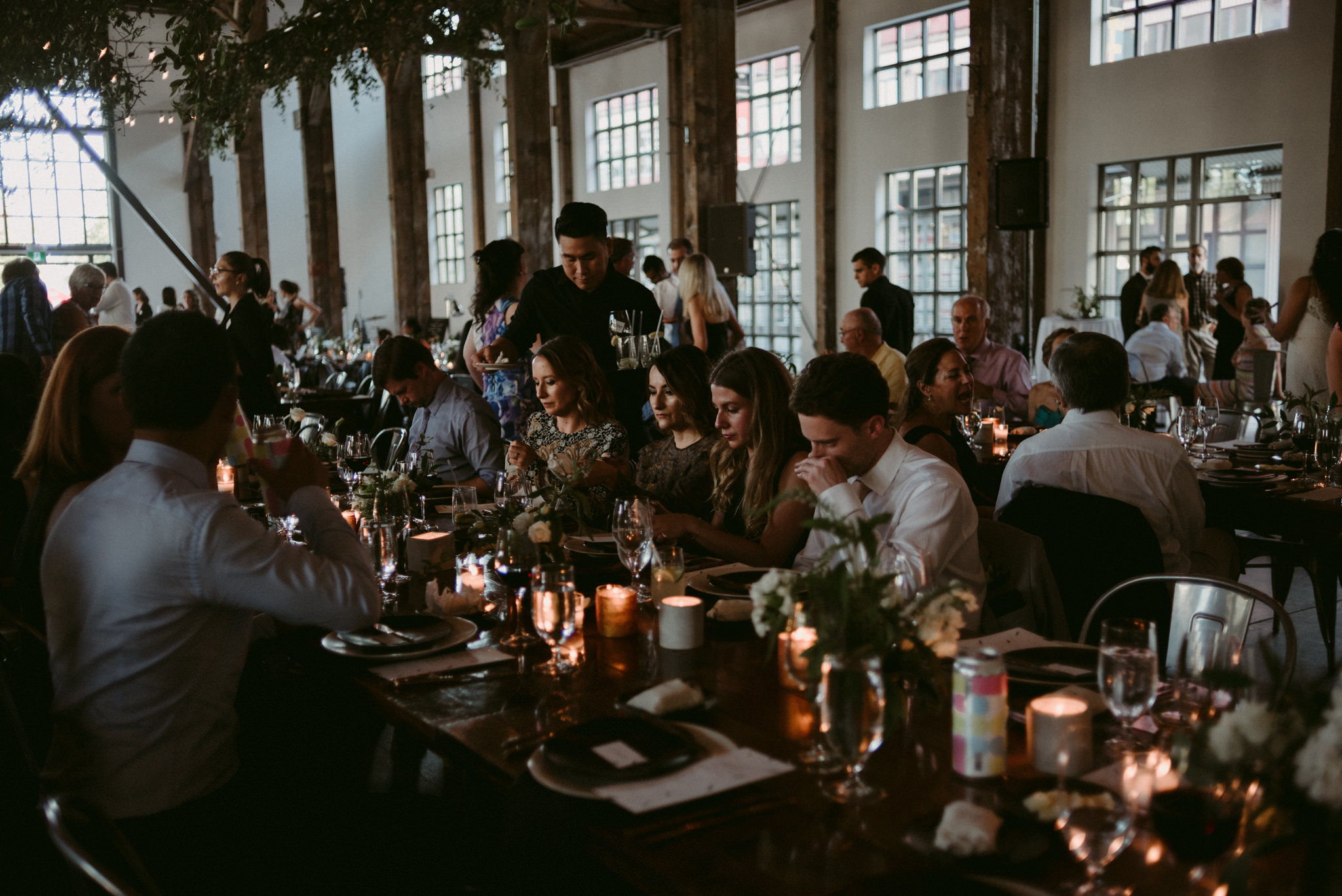 guests sitting at tables talking during wedding reception