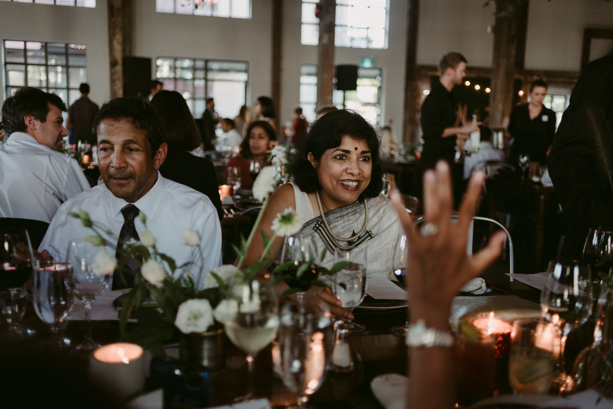 indian woman in sarii smiling at table