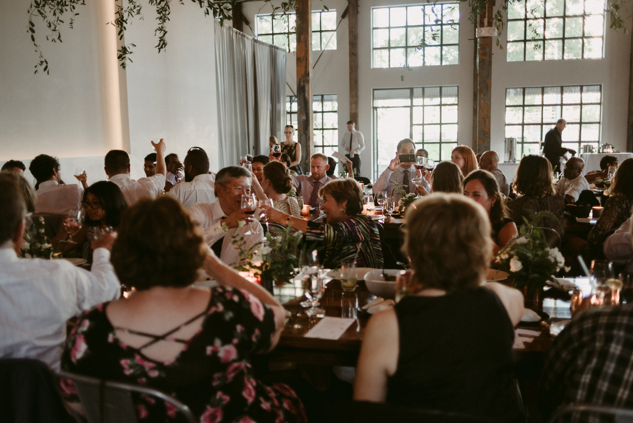 guests clinking glasses during wedding reception