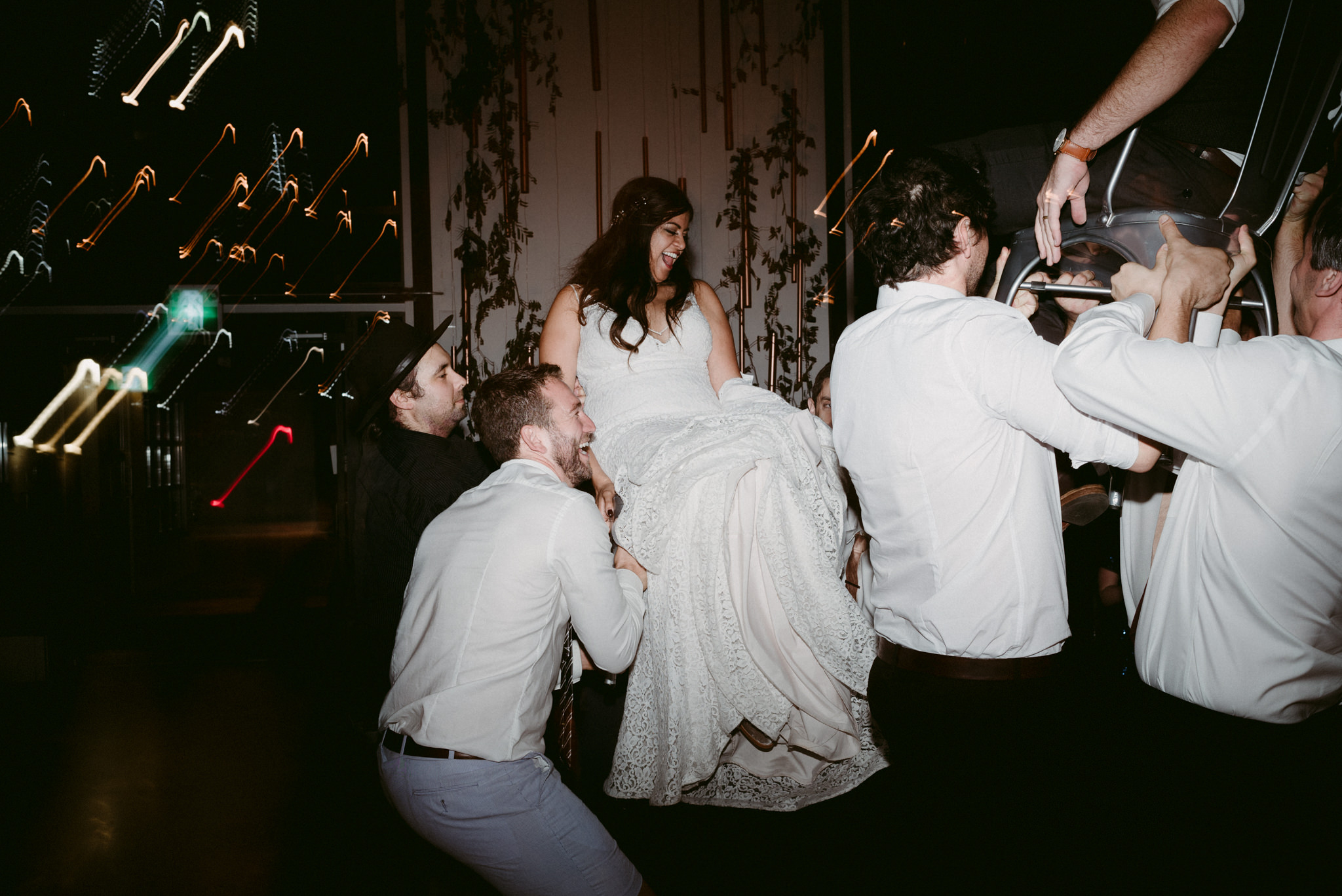 bride hoisted up in chair