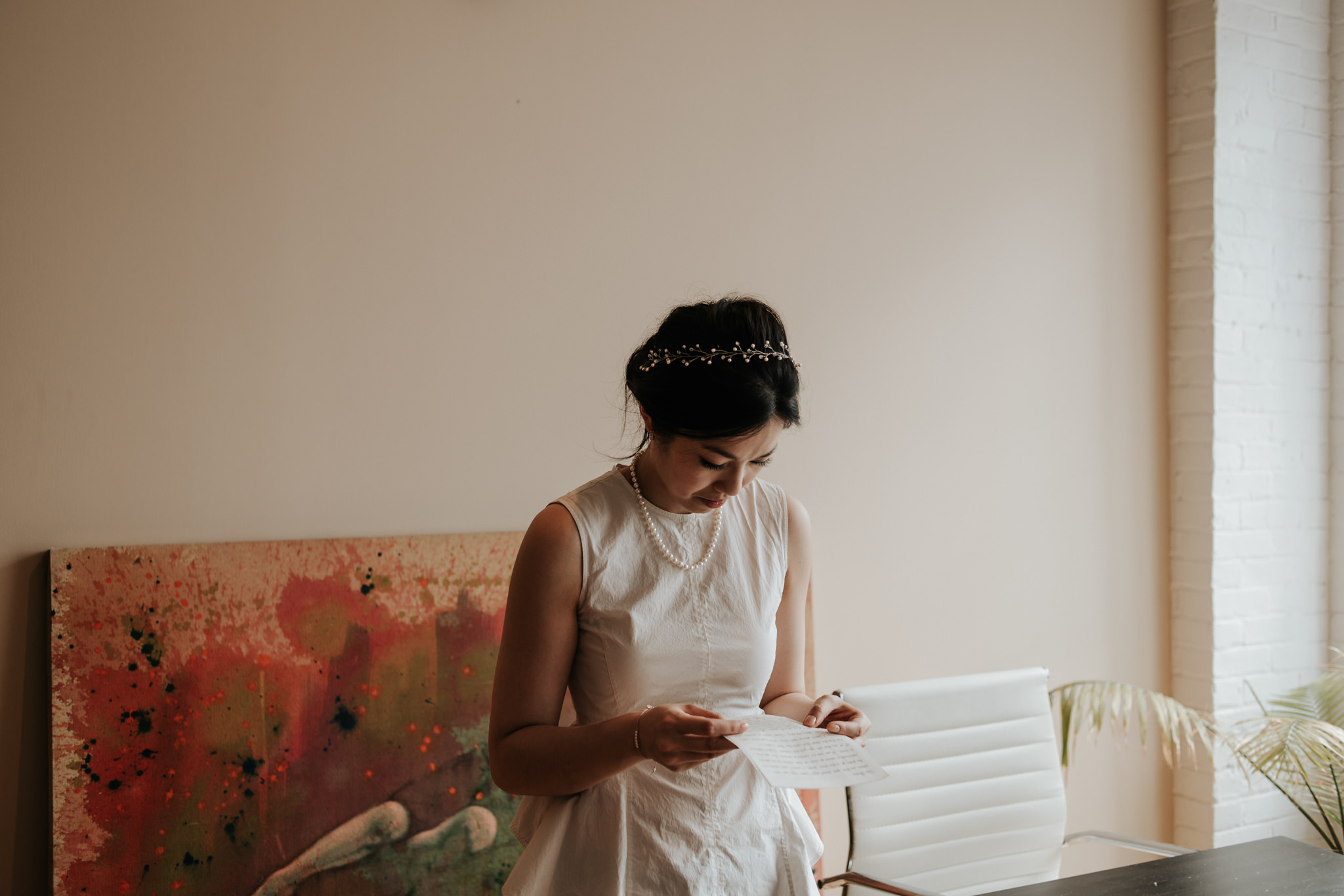 bride reading letter from groom in old loft